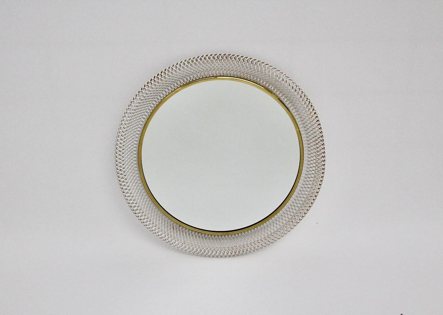 Mid Century Modern vintage circular wall mirror from white metal and brass mesh
Münchener Werkstätten 1960s Germany.
An elegant and stunning white metal and brass frame with mirror glass circular like with one mounting loop at the backside.
very