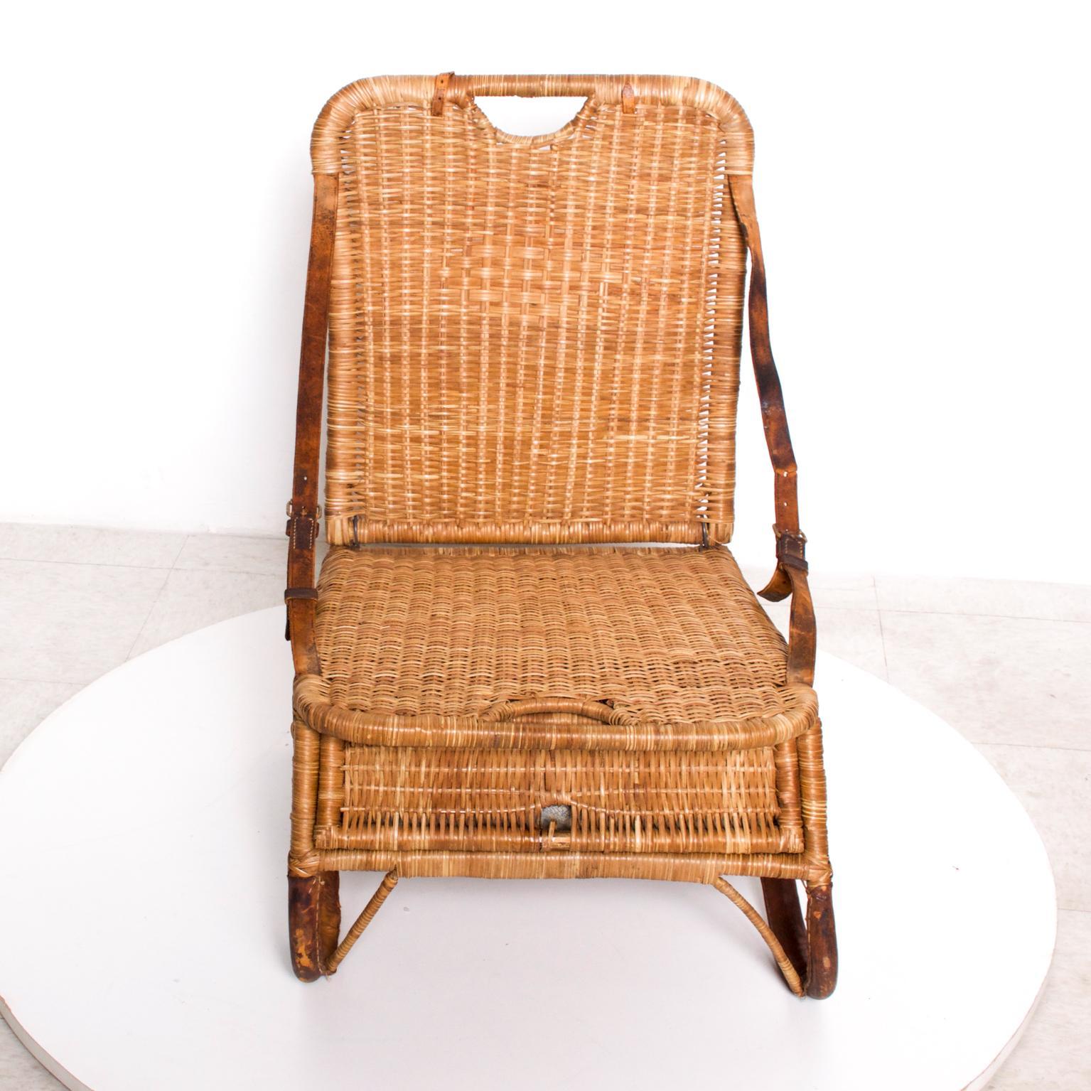 For your pleasure: compact portable traveling beach- fun in the park chair in woven wicker/rattan and leather.
Mid-century Modern Design vintage delight. Sculpted and Stylish Legs. Vintage Folding chair.
Dimensions are:29