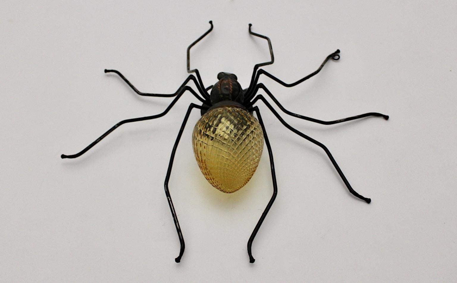 Mid-Century Modern vintage handmade spider fly wall light or sconce or table lamp from yellow grooved glass and metal.
The legs were made of partly black lacquered metal wire, while the body from copper and yellow structured glass.
This wall light