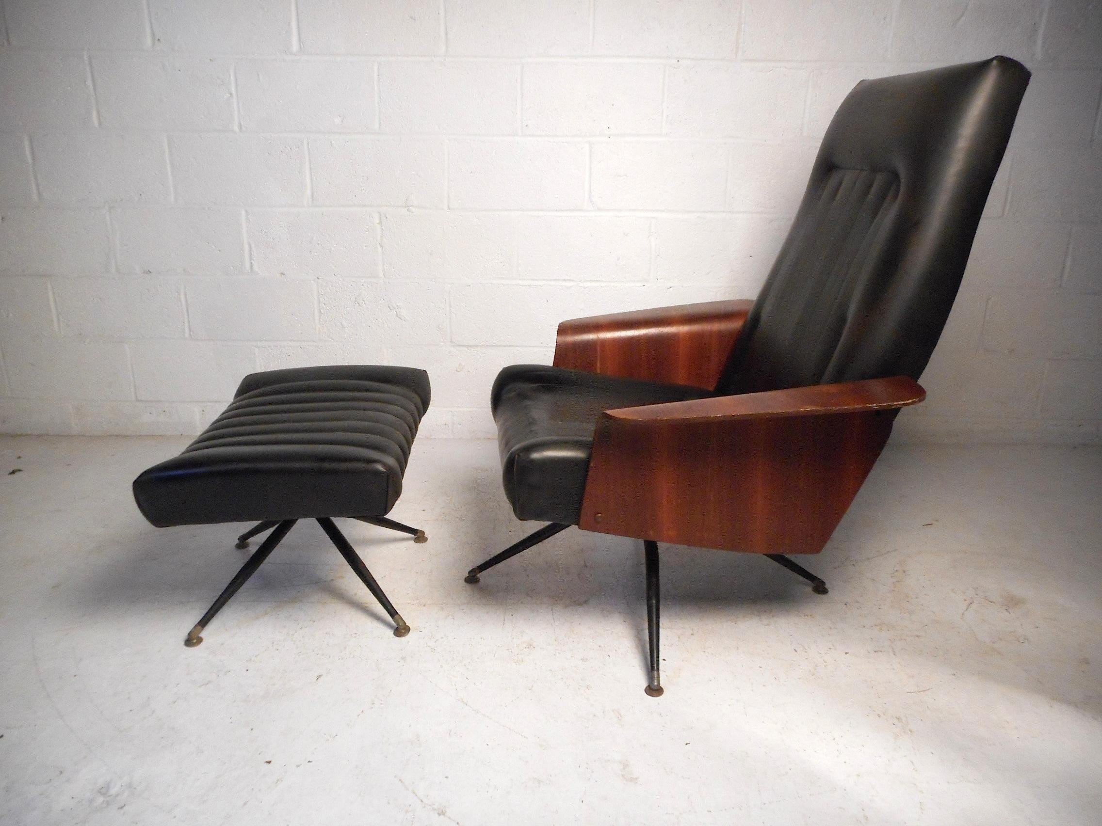 This stylish midcentury lounge chair and ottoman feature black faux-leather upholstery, molded plywood armrests, and swivelling bases on both the chair and ottoman. This set is sure to provide a great addition to any modern interior. Please confirm