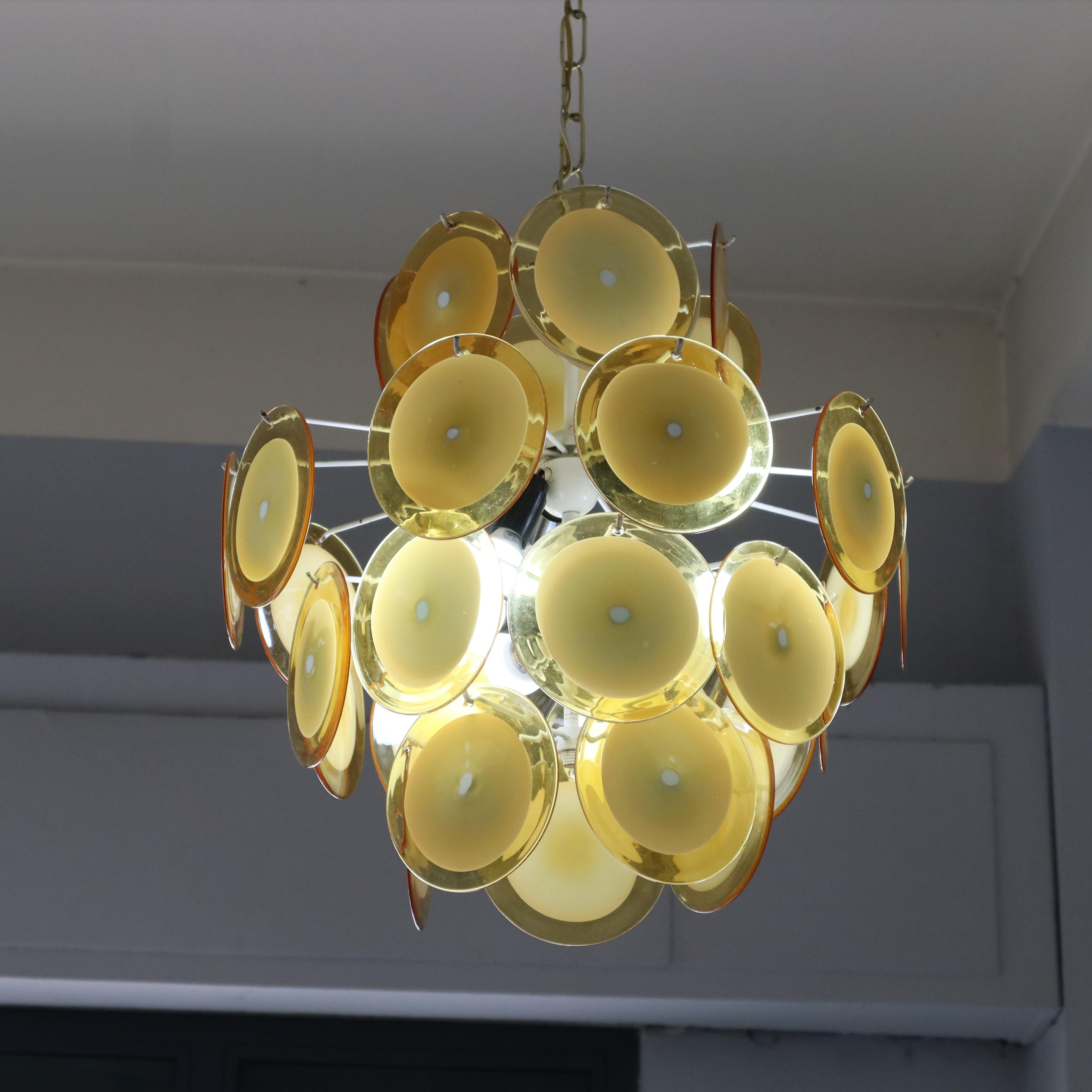 Mid-Century Modern Yellow Murano Glass Disc Chandelier in the Style of Vistosi, Italy, 1960s

This stunning Murano chandelier, crafted in the style of Vistosi, exemplifies the fine art of Italian glassmaking from the 1960s. The chandelier features