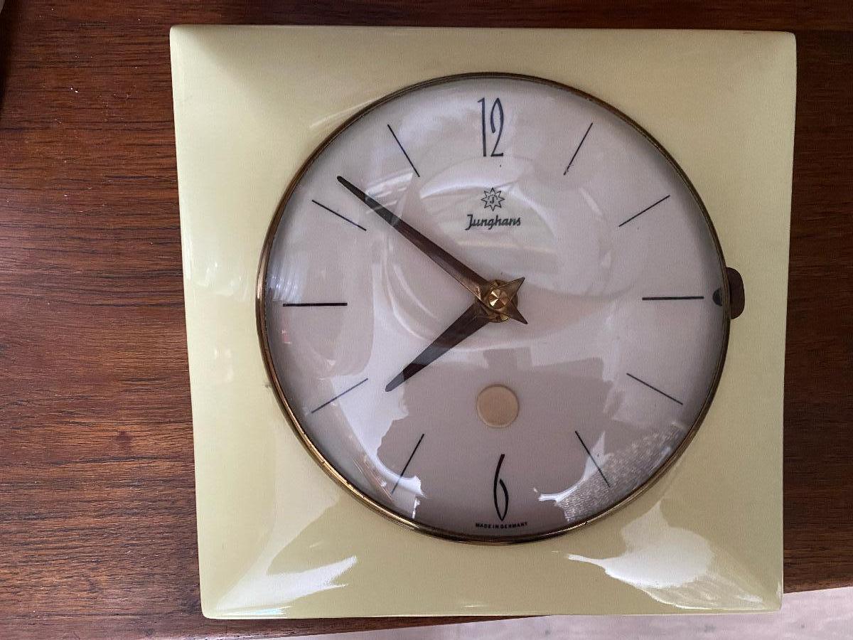 Very much Mid-Century in soft yellow colour wall clock from Junghans Germany. Electric, battery operated. 