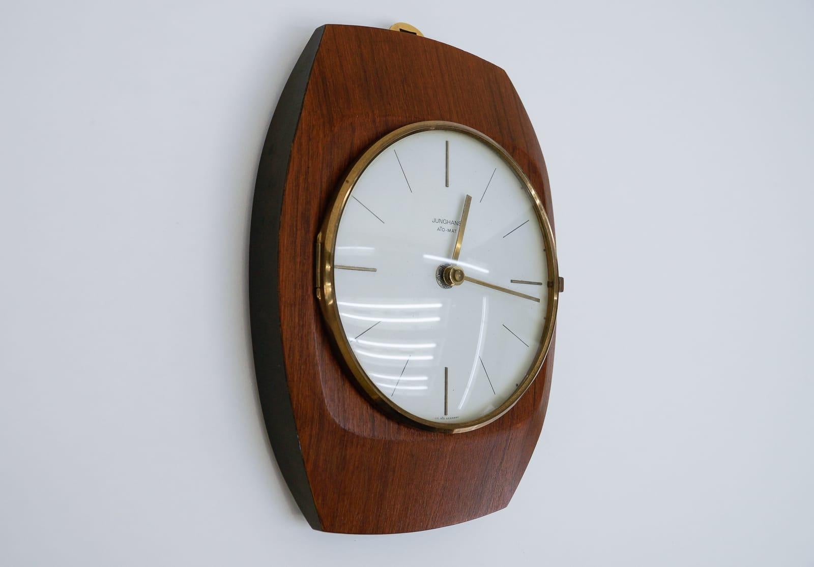 The brass ring allows it to be suspended.

Made in Germany.

Electric, battery operated clock.
