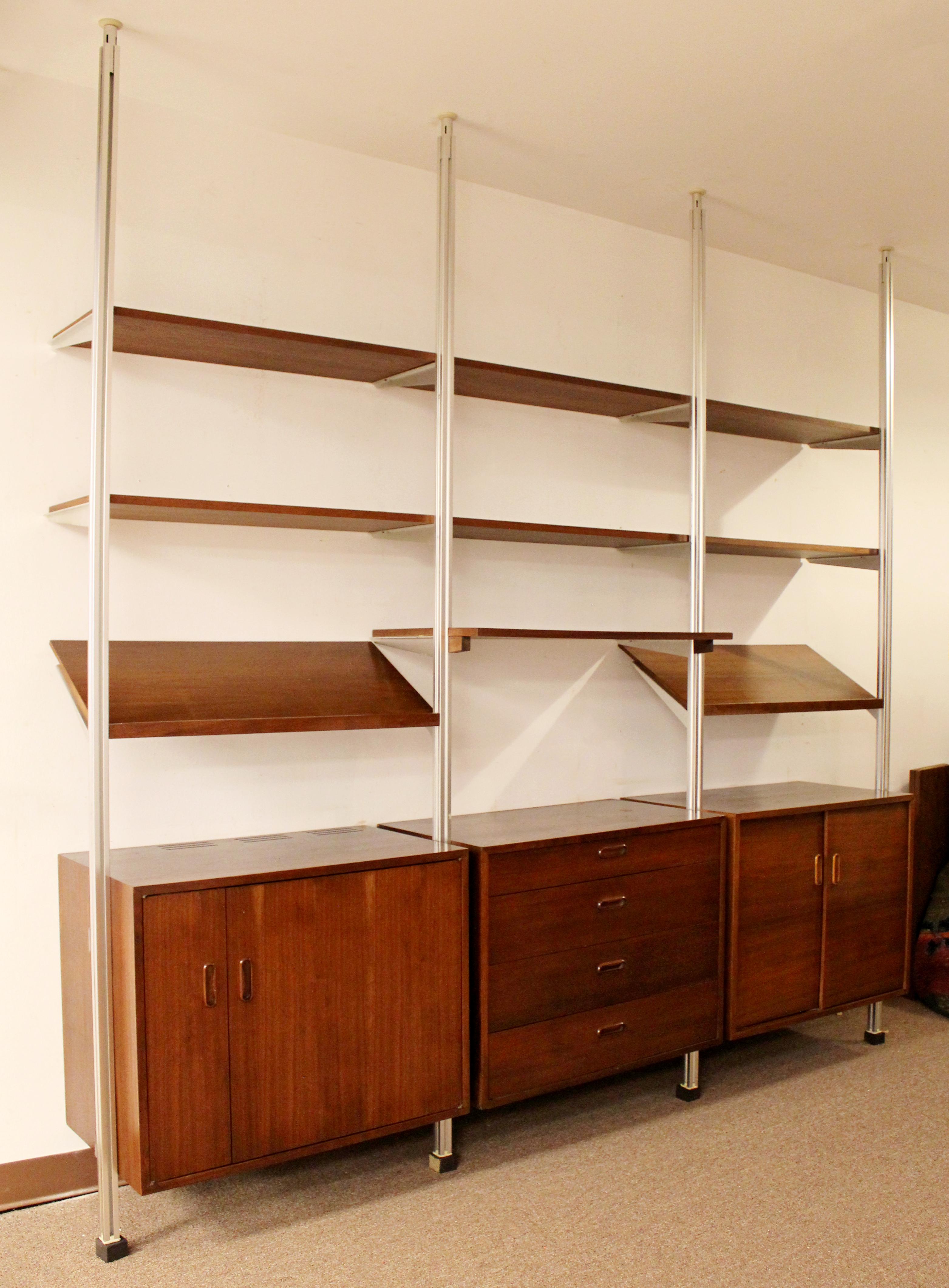For your consideration is a fantastic, walnut wood, three bay bookcase wall omni unit, with four drawers, by George Nelson, circa the 1960s. In very good condition. The dimensions are 97.5
