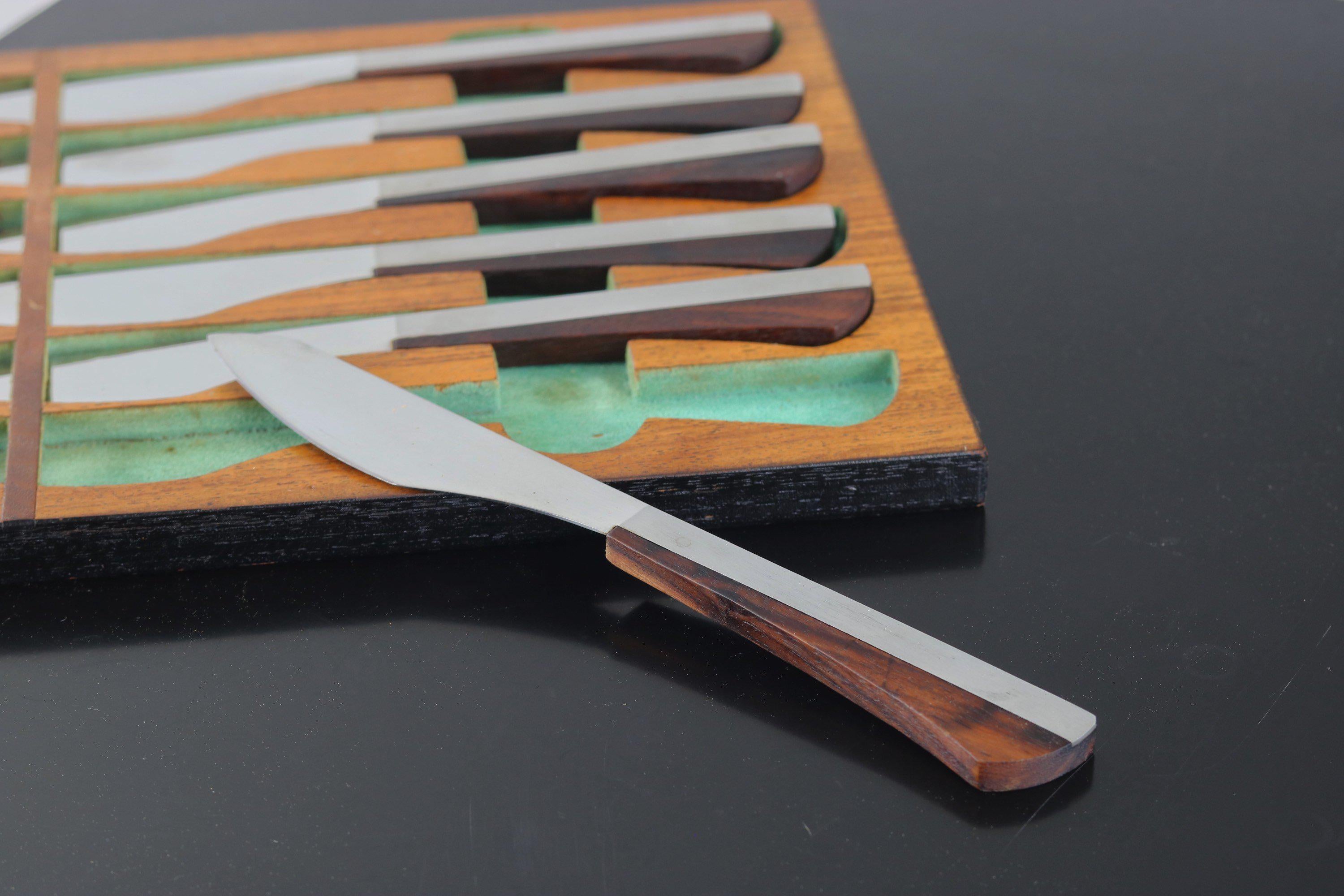 Eye-catching cutlery as art! The set of six knives are constructed with rosewood handles wrapping stainless metal blades made in Japan. The case for the knives can stow in your drawer or better yet mount on your wall for display with it's original