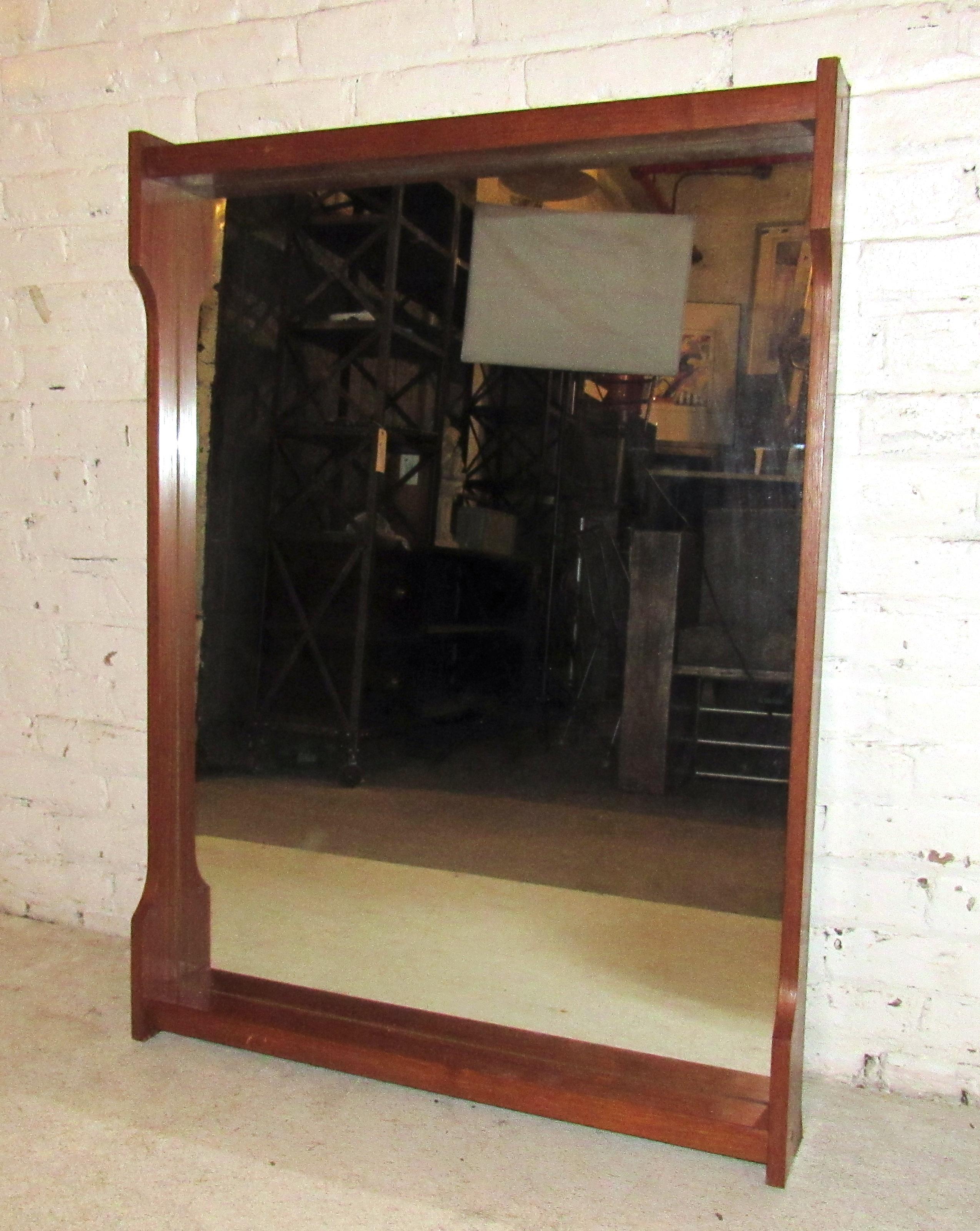 Sleek vintage modern wall mirror featuring a small shelf, stamped RS.

(Please confirm item location - NY or NJ - with dealer).