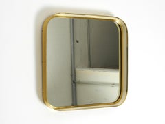 Mid Century Modern wall mirror with heavy brass frame by Münchener Zierspiegel