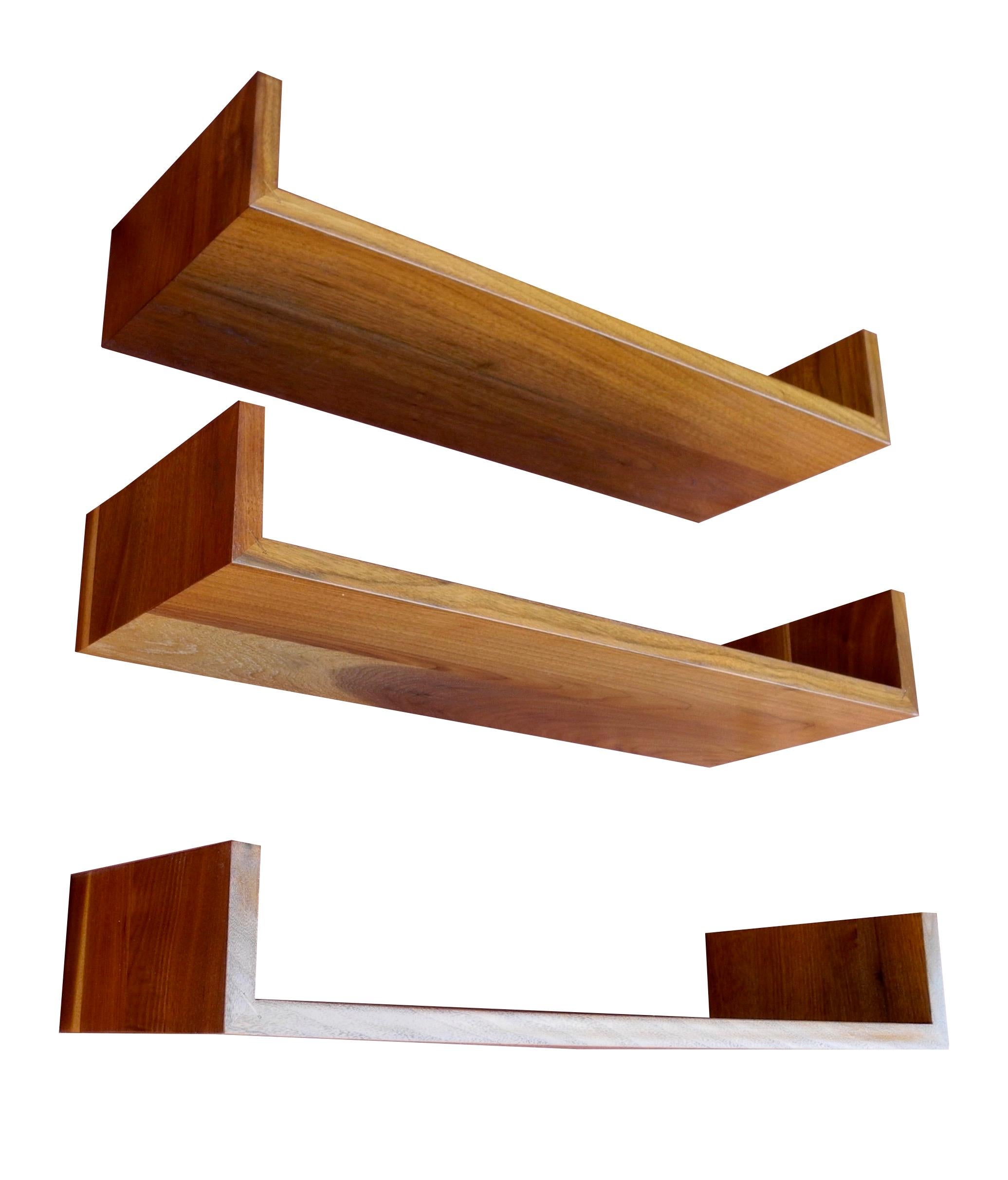 Hang these handsome wall mount walnut shelves at any height and configuration. Designed by Mel Smilow, these three modern shelves are 24 