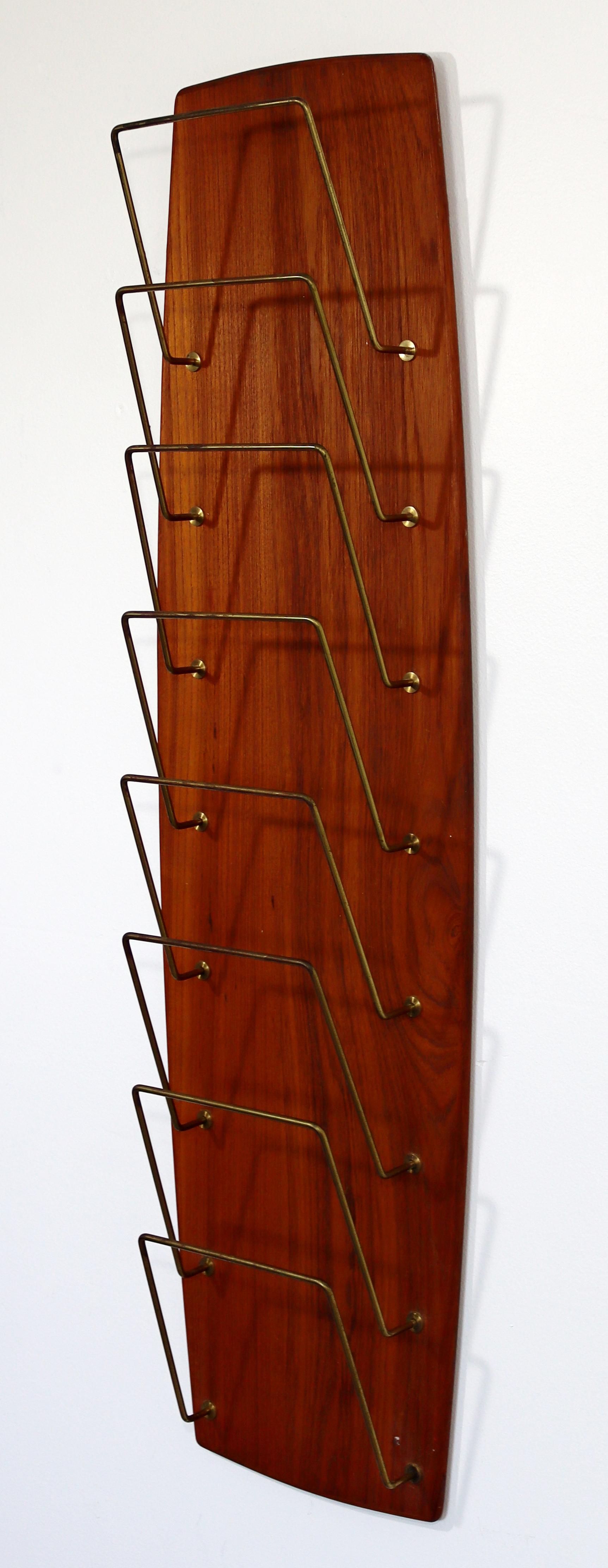 For your consideration is a delightful, Danish, wall mounted magazine rack, with brass racks, circa the 1960s. In excellent vintage condition. The dimensions are 11