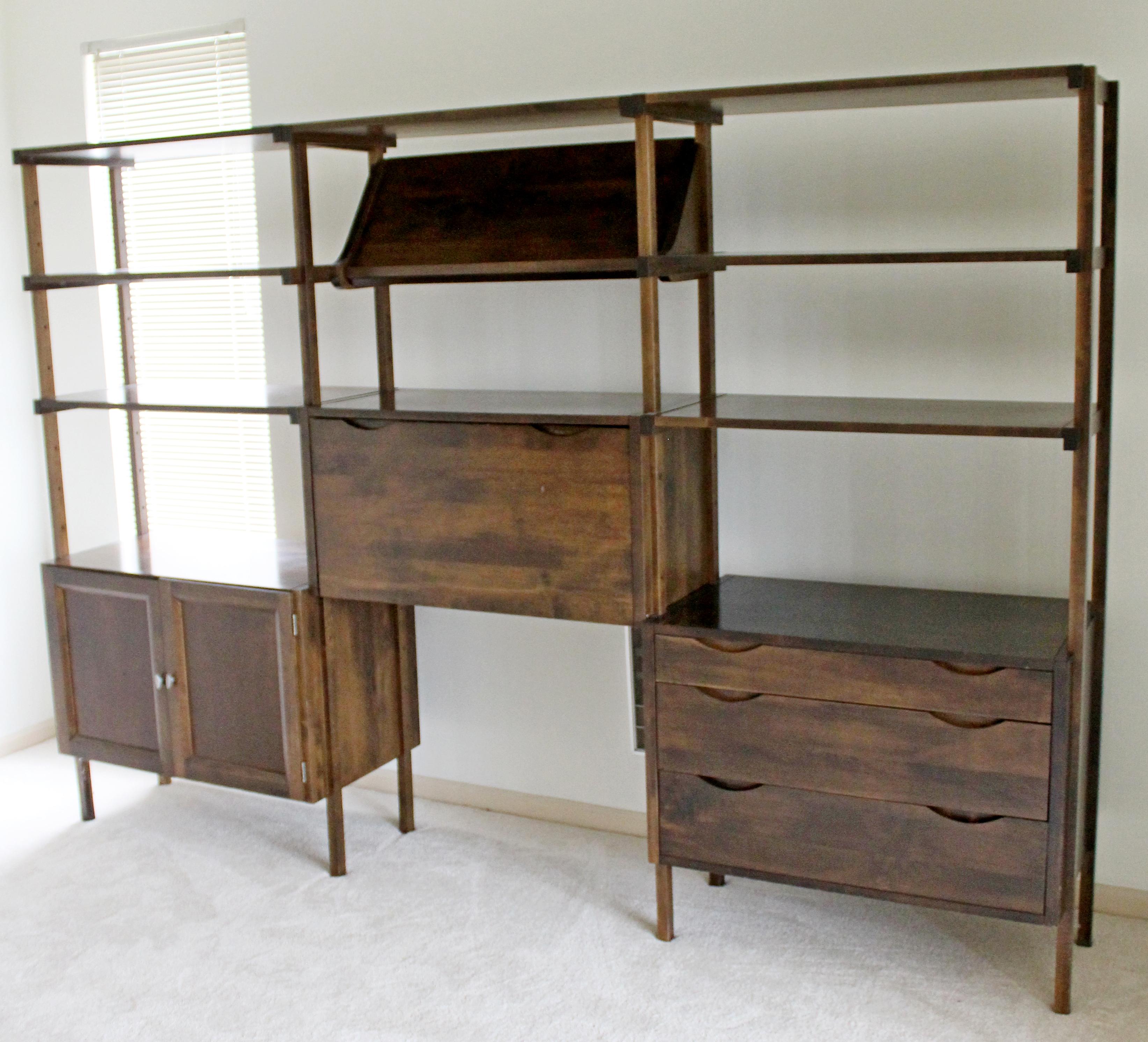 For your consideration is a wonderful walnut wood bookcase wall unit, with several compartments, cabinet, drawers, drop down desk, magazine rack and shelfs circa the 1960s. In good vintage condition. The dimensions are 97