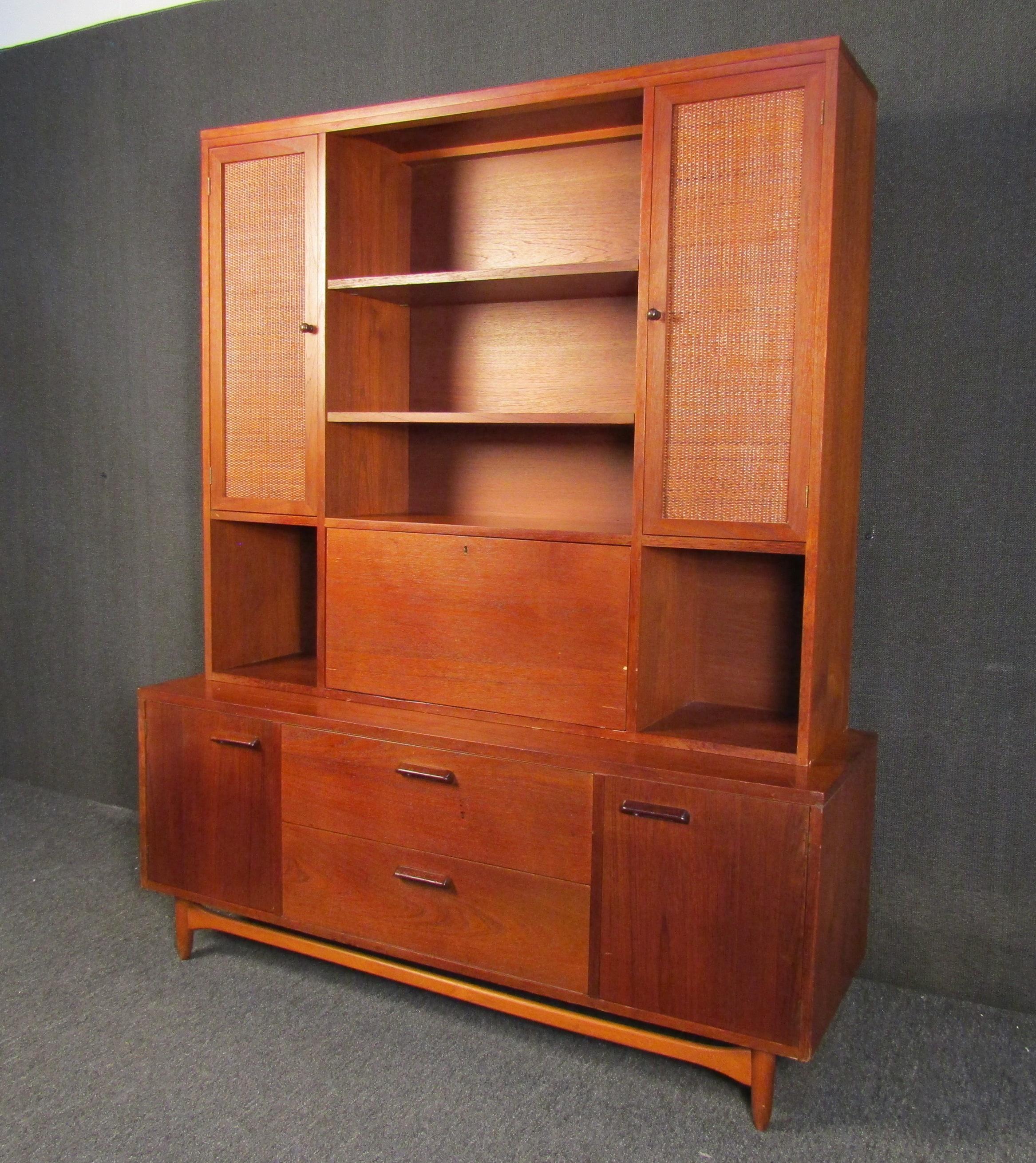 An incredible walnut Mid-Century Modern wall unit by acclaimed furniture maker Lane. Made in the USA with solid craftsmanship and timeless design, this wall unit is a lasting addition to any home sure to be around for generations. Please confirm