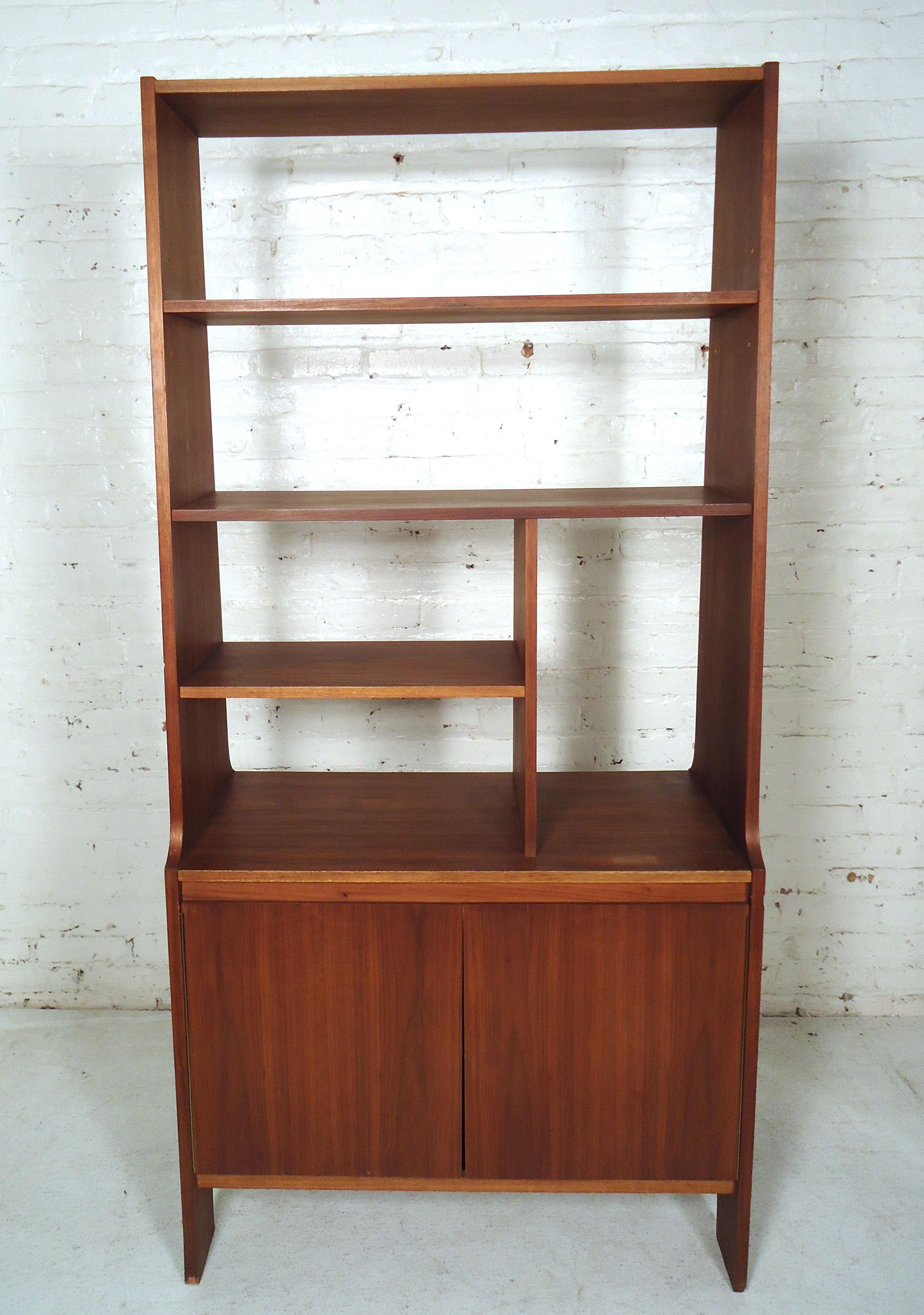 Vintage modern standing wall unit with a lower storage compartment, shelves, made of rich walnut grain.
(Please confirm item location - NY or NJ - with dealer).