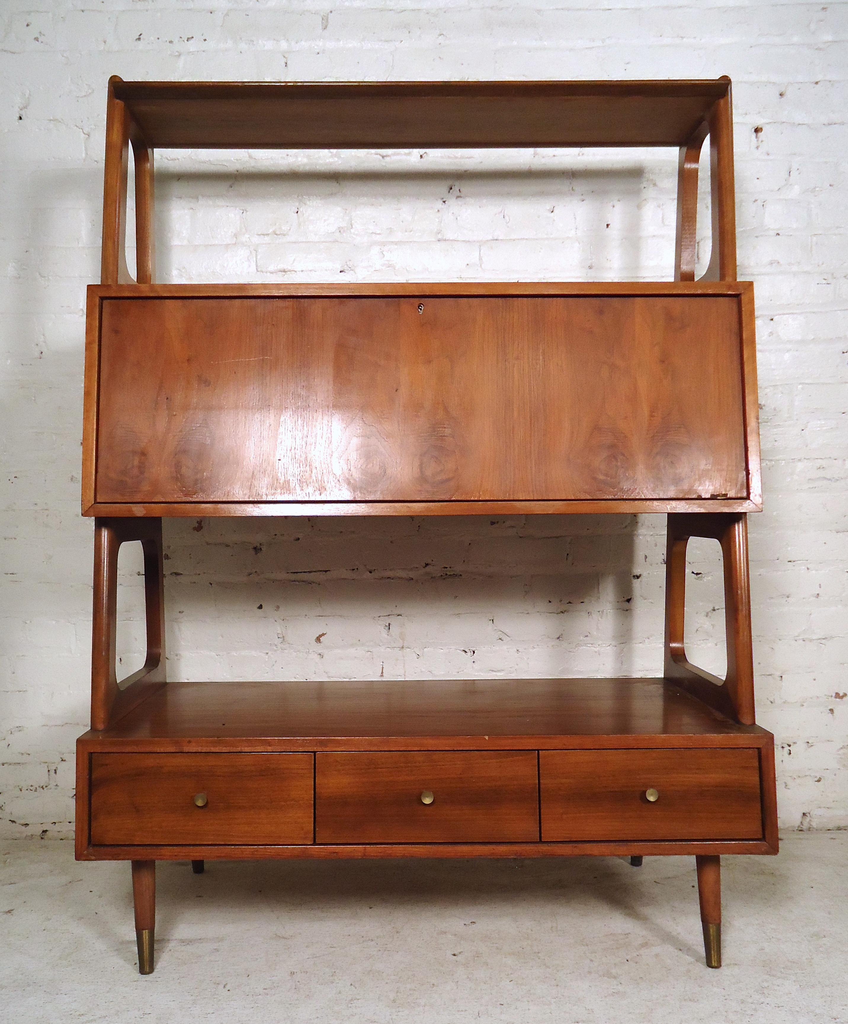 Unique vintage modern standing wall unit featuring a large storage compartment in the center, three spacious drawers at the bottom with brass pulls and sturdy splayed legs that keep this piece standing. 

(Please confirm item location - NY or NJ -