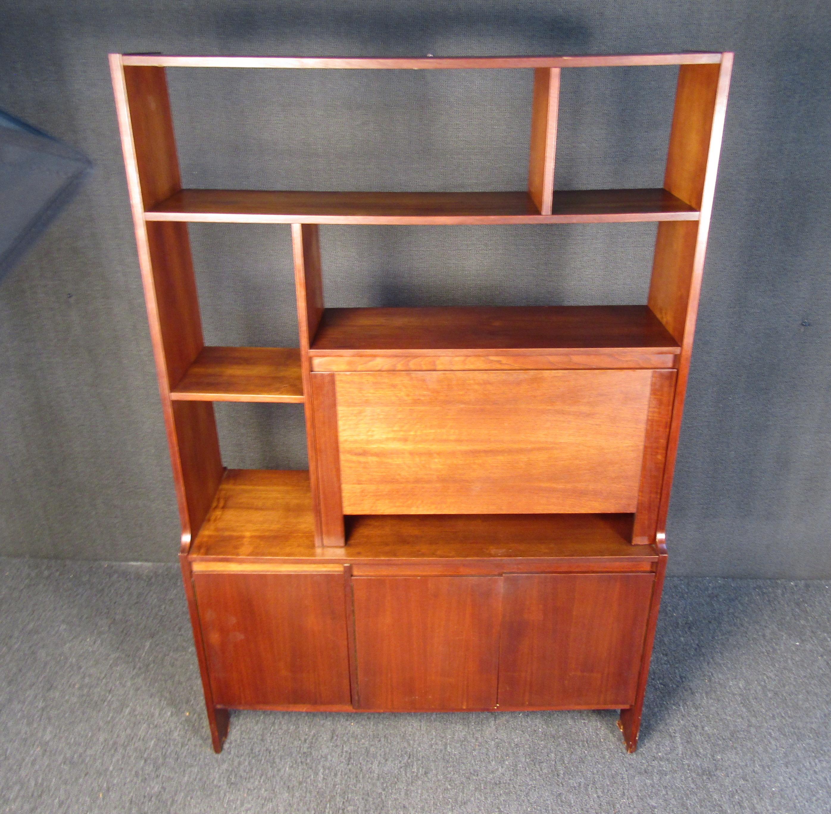 Perfect for adding timeless Mid-Century Modern style to any room, this sturdy wall unit can complement personal decorations arranged on its shelves and add organization to a space. Please confirm item location with seller (NY/NJ).