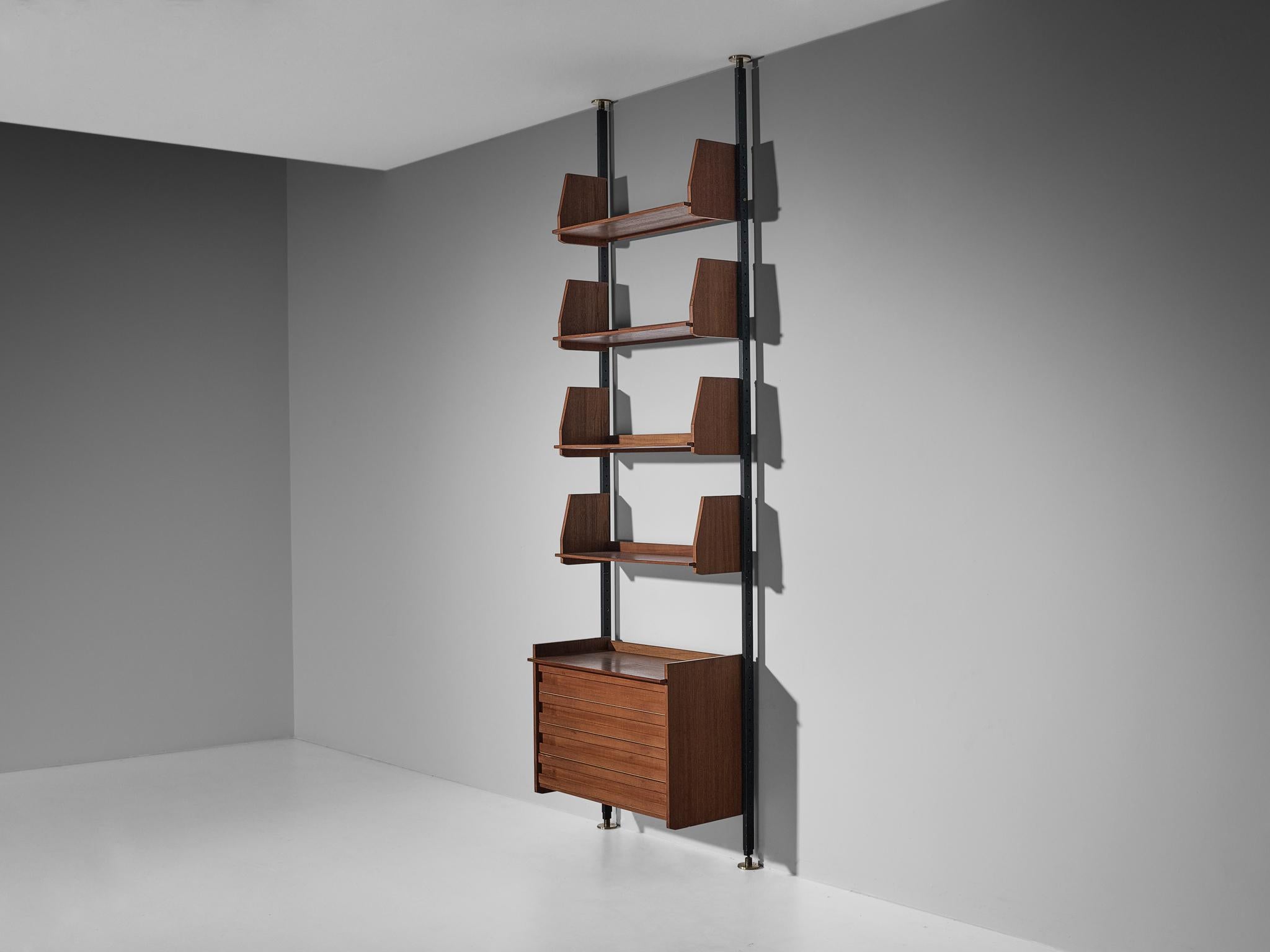Wall unit, teak, coated steel, brass, Europe, 1950s 

Both aesthetics and functionality comes into play in this bookcase; elegant in line and practical to use for any environment. This model has one vertical column structured by teak wood shelves