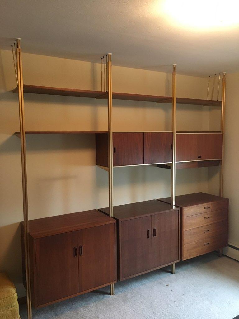 Fabulous wall unit by George Nelson which consists of 3 large storage cabinets, 2 smaller cabinets one with drawers, one with doors and shelves 3. Larger cabinets are 30.75 W x 18.25 D x 24 H. One has 4 drawers other 2 have doors with a shelf. All