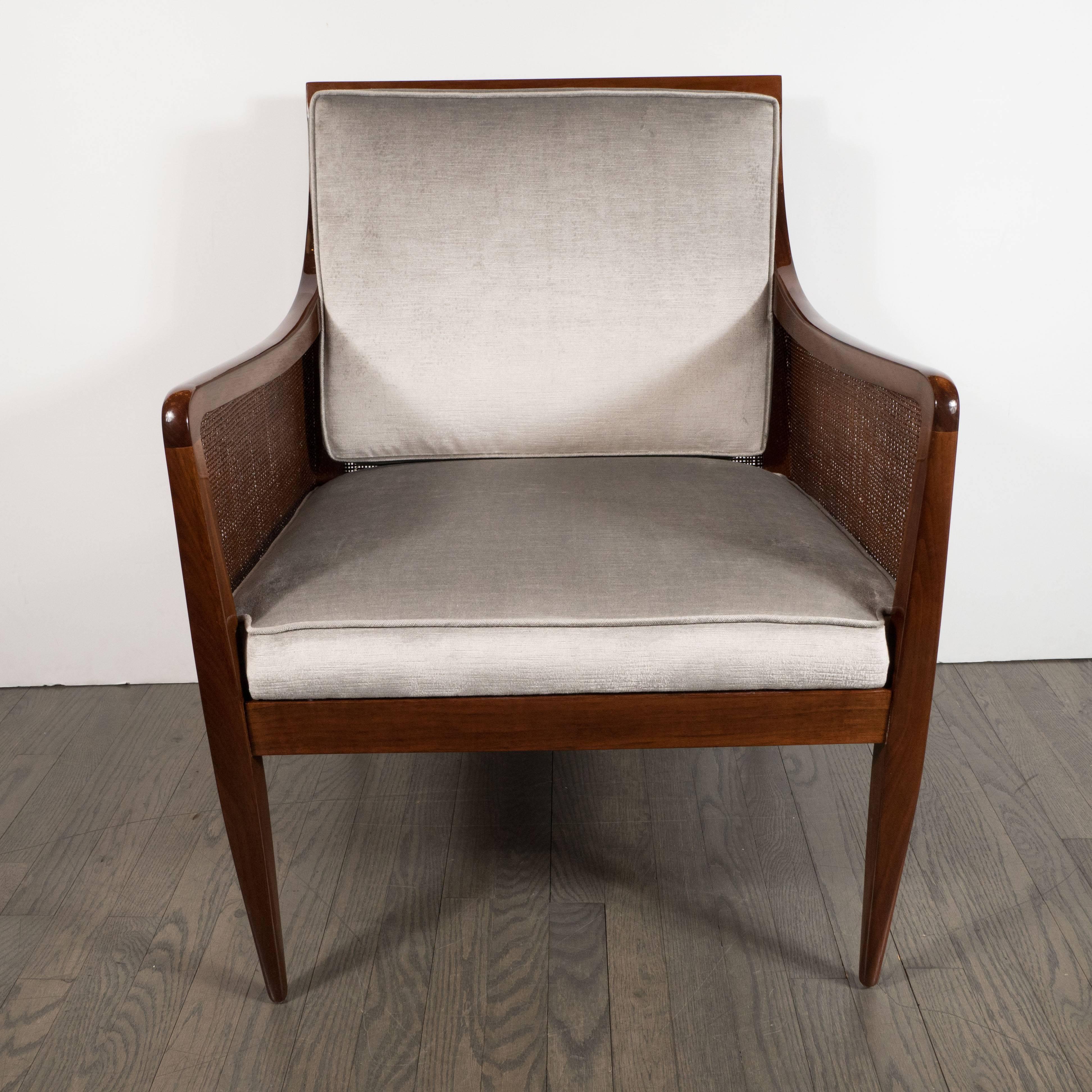Sophisticated, elegant and unfussy, this chair represents the qualities that discerning collectors of first rate American Mid-Century Modern design prize. Realized circa 1960, this walnut chair features tapered rectangular legs with streamlined arms