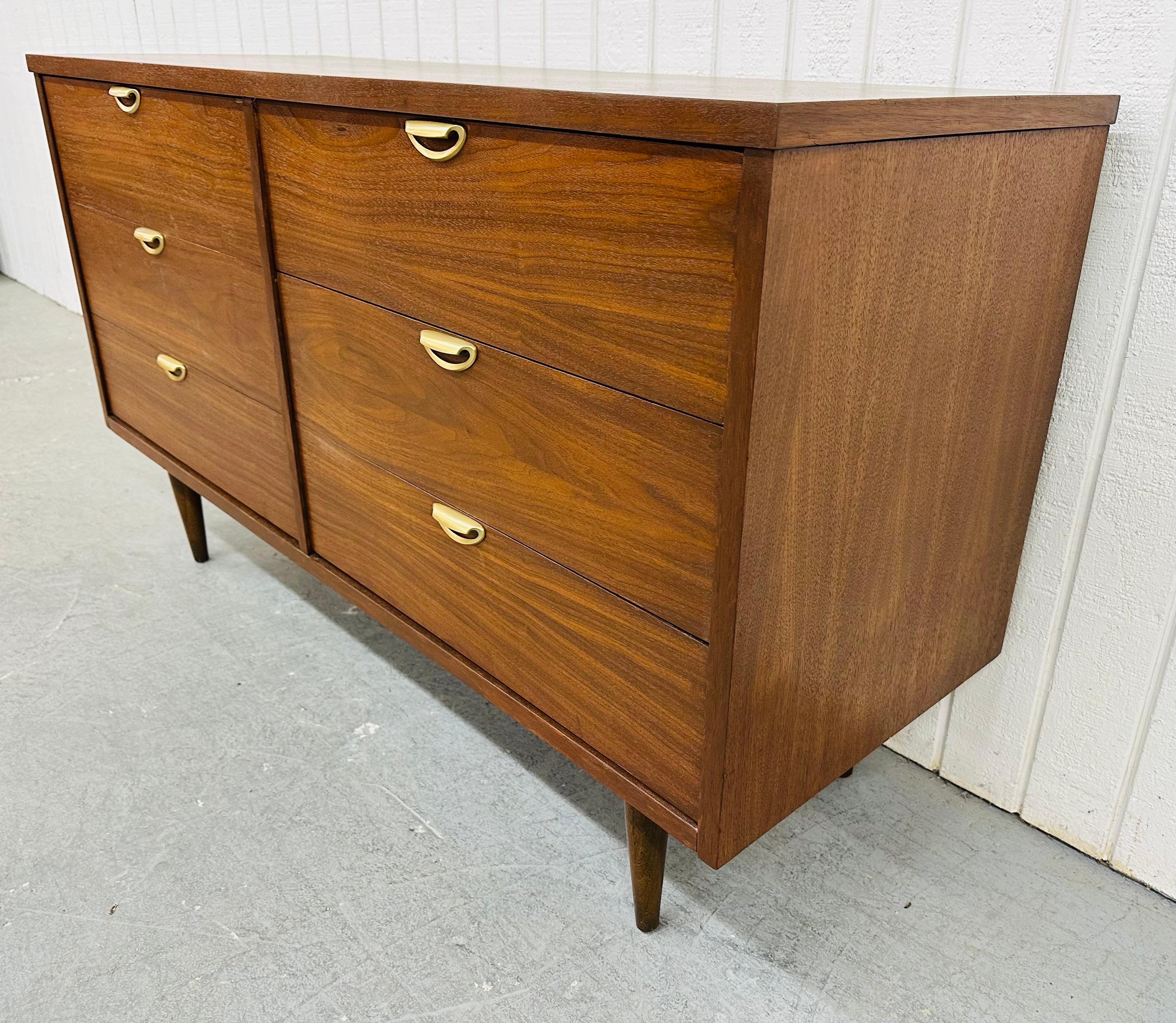 This listing is for a Mid-Century Modern Walnut Dresser. Featuring a straight line design, six large drawers for storage, original brass pulls, modern legs, and a beautiful walnut finish. This is an exceptional combination of quality and design!