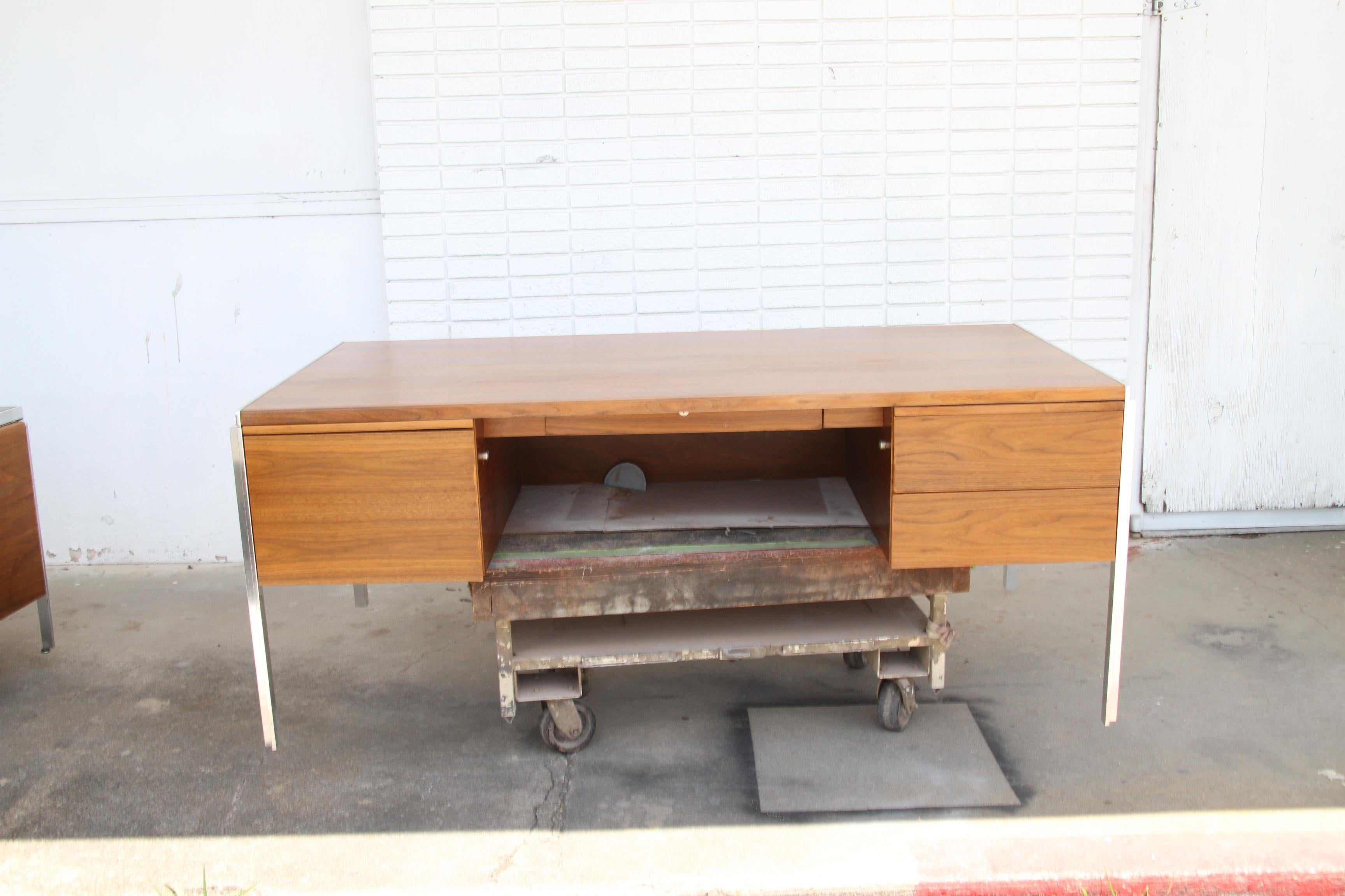 Mid-Century Modern Walnut and Aluminium Desk by Alexis Yermakov for Stow Davis
1970s

Clean lines with aluminium accents, this minimalist design features ample leg room, 4 drawers (one file)  and a pull out tablet work surface. 

See credenza also
