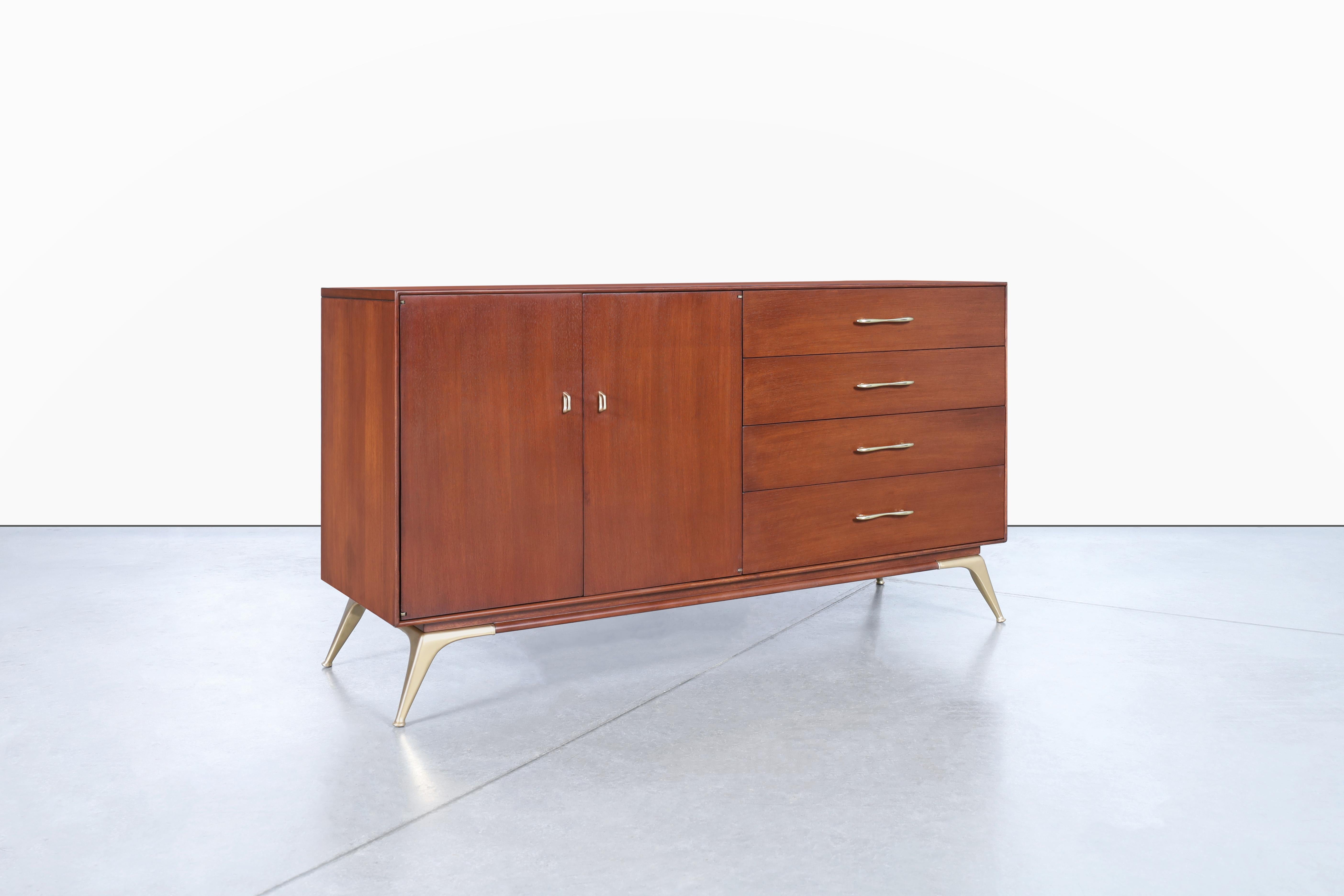 Mid-Century modern walnut and brass credenza manufactured by R-Way in the United States, circa 1960s. Take a moment to admire the stunning brass hardware of this beautiful credenza which bears a unique design reserved for R-Way's premium furniture