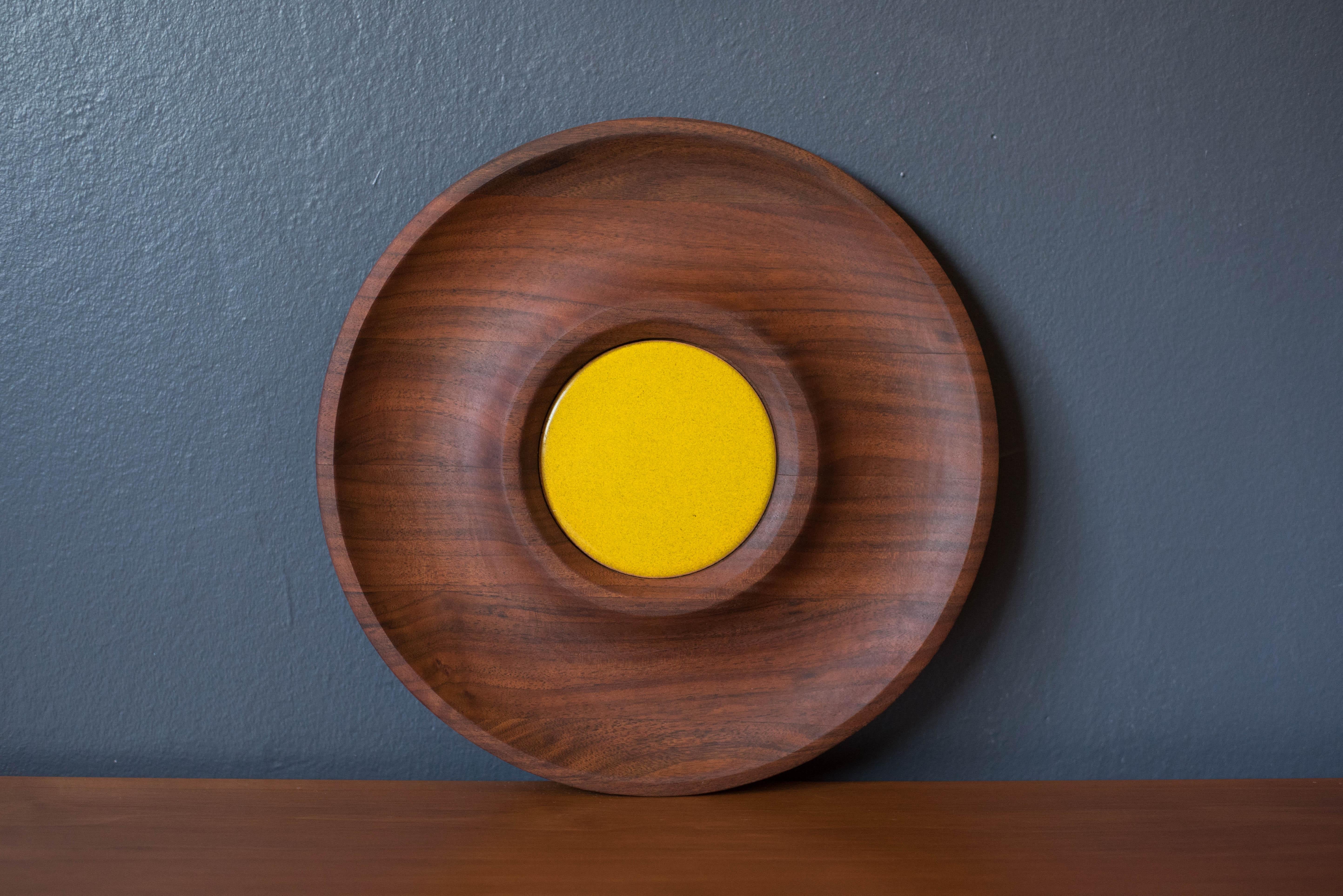 Vintage round tray platter in walnut manufactured by Bey-Cor Creations, U.S.A. This decorative serving dish displays rich walnut grains and includes a ceramic inset tile in chartreuse yellow festive enough for entertaining with dips and appetizers.