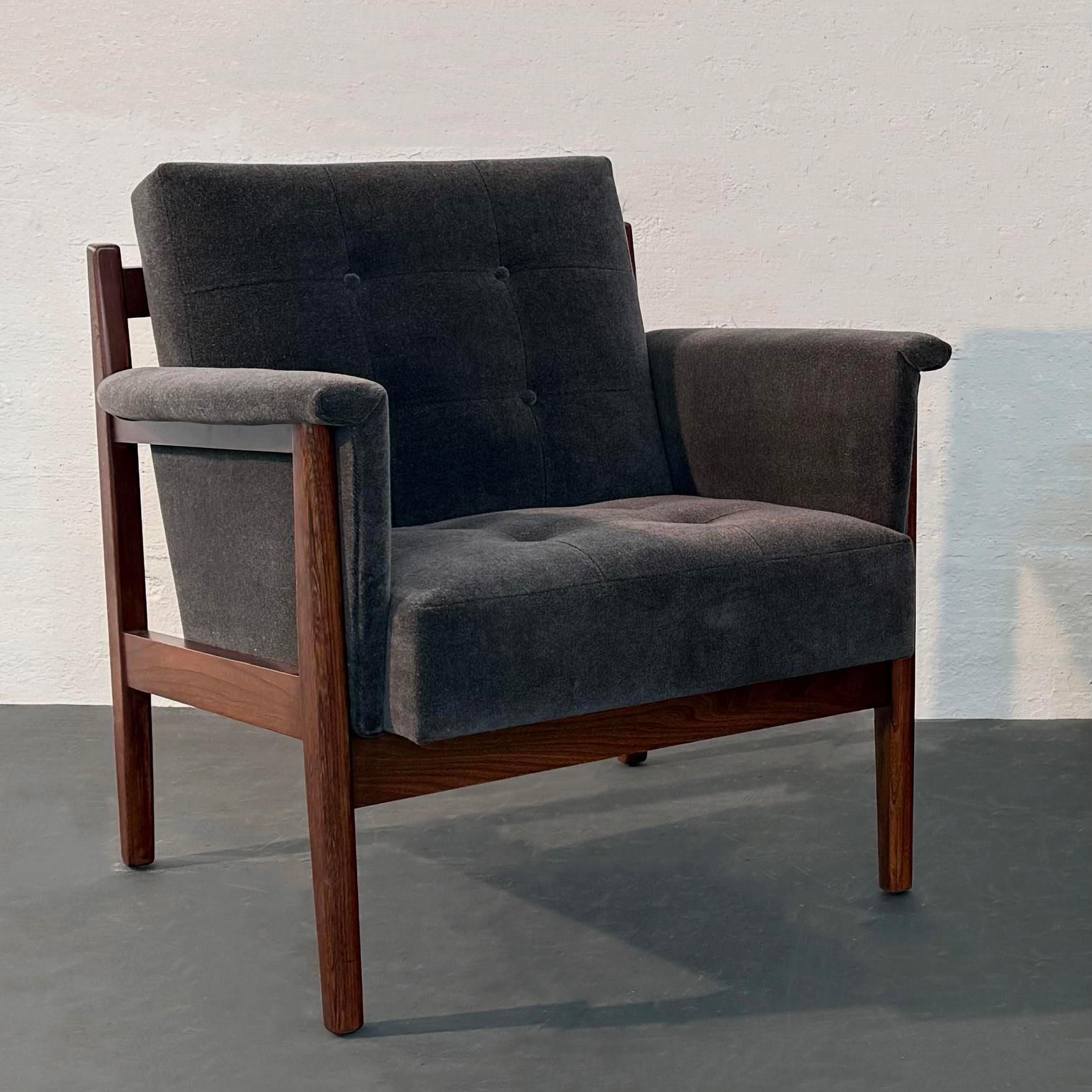 This beautifully crafted Mid-Century Modern lounge chair by the Paoli Chair Company in Orleans, Indiana circa 1965 features a solid walnut frame with an exposed horizontal back slat. It is newly upholstered in a soft and cozy dark gray chenille with