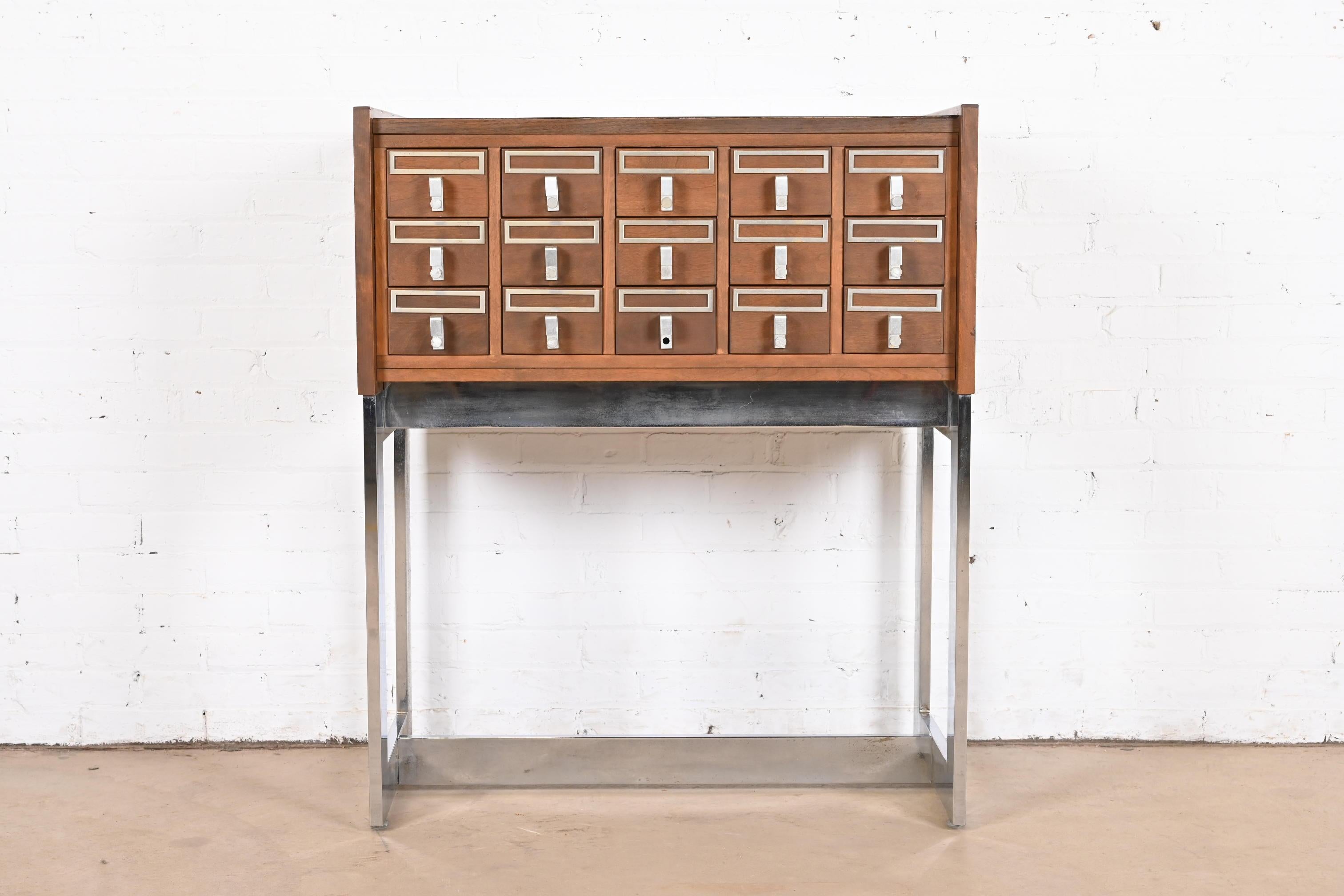 A rare Mid-Century Modern 15-drawer library card catalog or file cabinet

USA, Mid-20th Century

Walnut, with durable laminate top, and chrome base.

Measures: 35