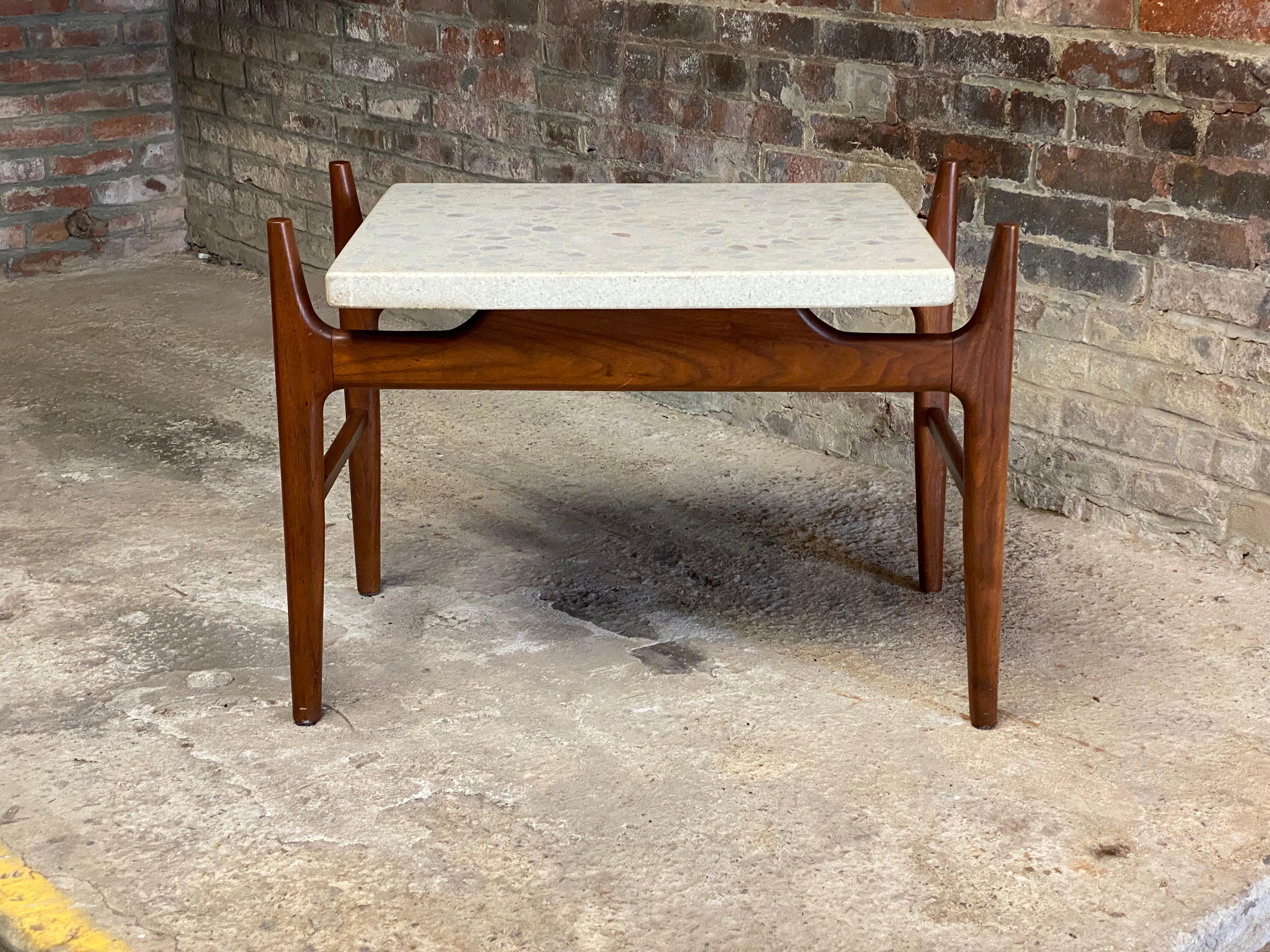 Solid oiled walnut with a rectangular thick terrazzo top. Tapered and extended legs that come up and over and away from  the terrazzo top to give it a floating appearance. Circa 1960.

Good overall condition with no major visible chips, cracks or