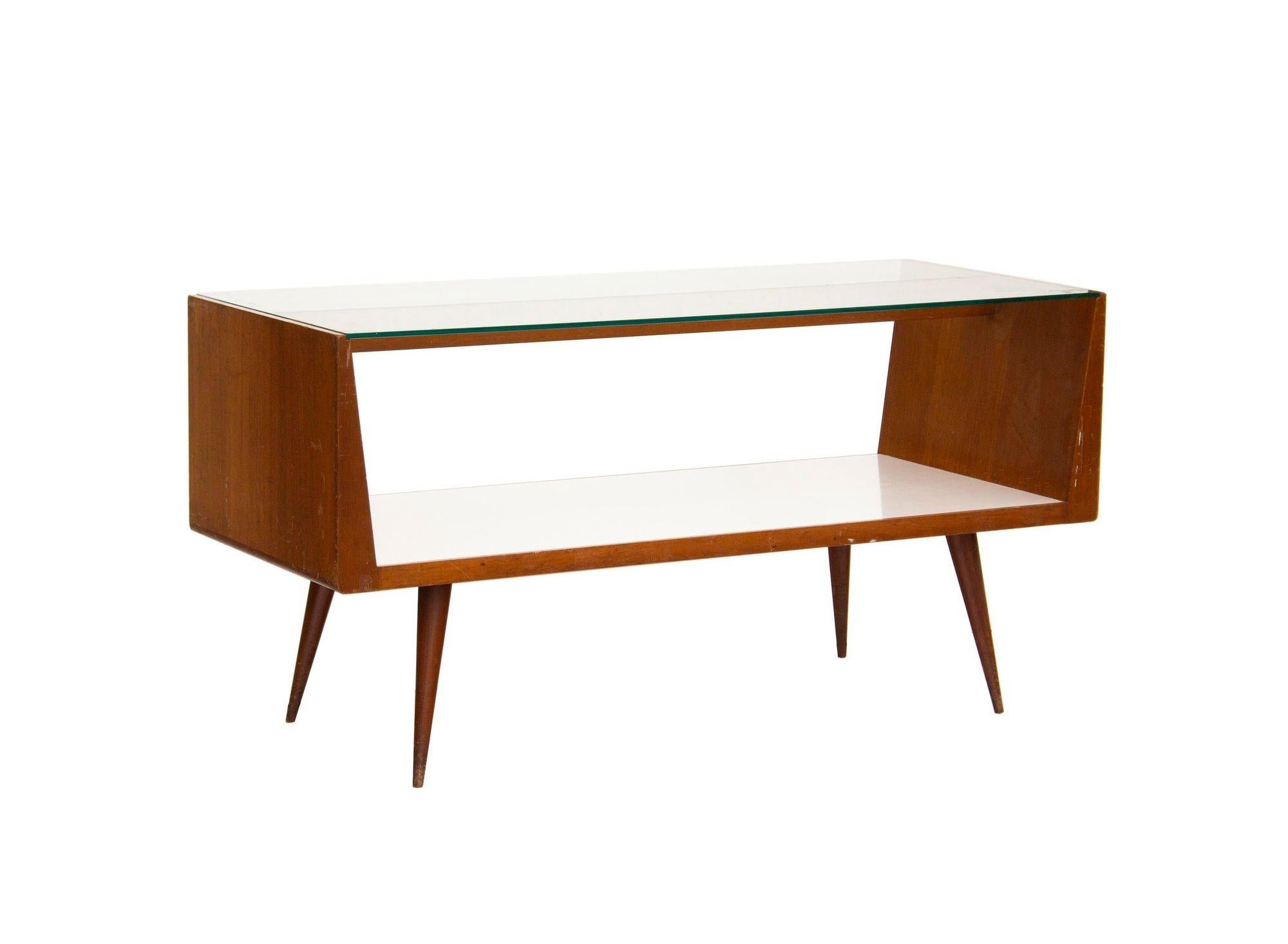 USA, 1960s
A matched pair of midcentury modern walnut and glass display cases. These were likely originally used as some kind of retail store display. They have striking angular lines in warm old growth walnut, a white laminate surface, and thick