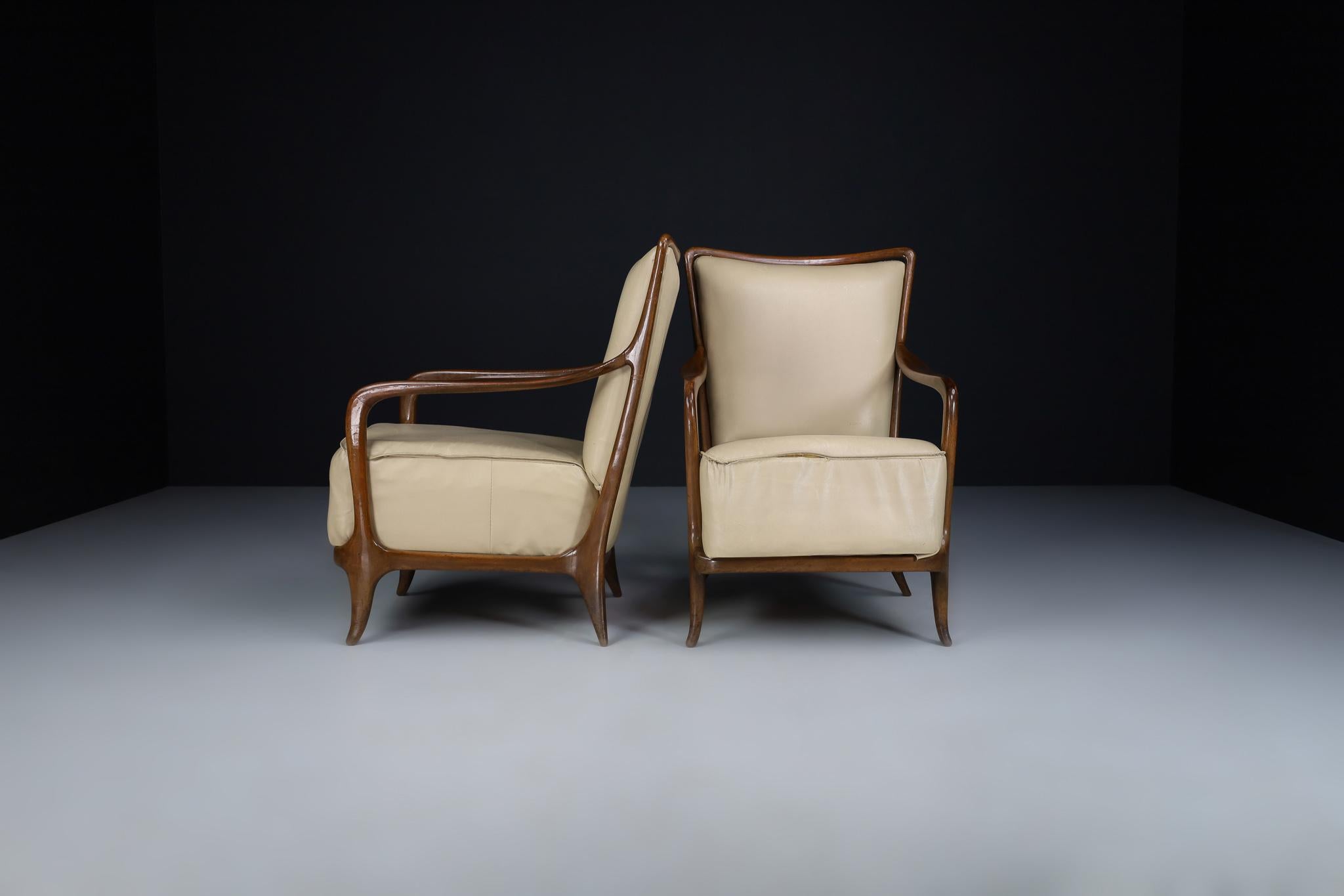 Mid-Century Modern walnut and leather armchairs by Paolo Buffa, Italy 1950s

Mid-Century Modern Italian pair of lounge chairs made of hand-carved polished Cherrywood, designed by Paolo Buffa in good condition. The armchairs' backrests and sides