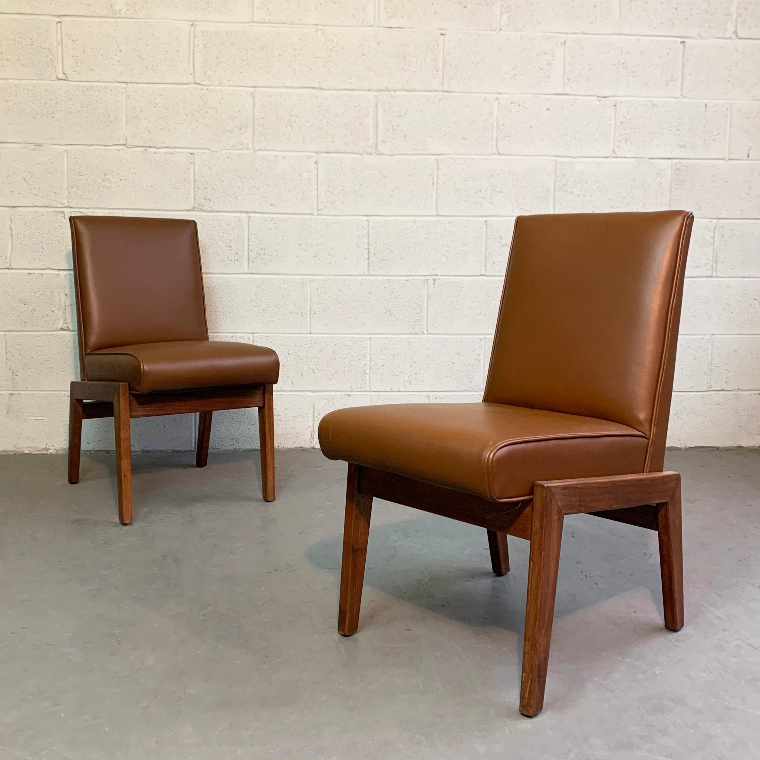 Mid-Century Modern, side chairs atrributed to Jens Risom feature walnut frames with caramel brown Naugahyde upholstery.