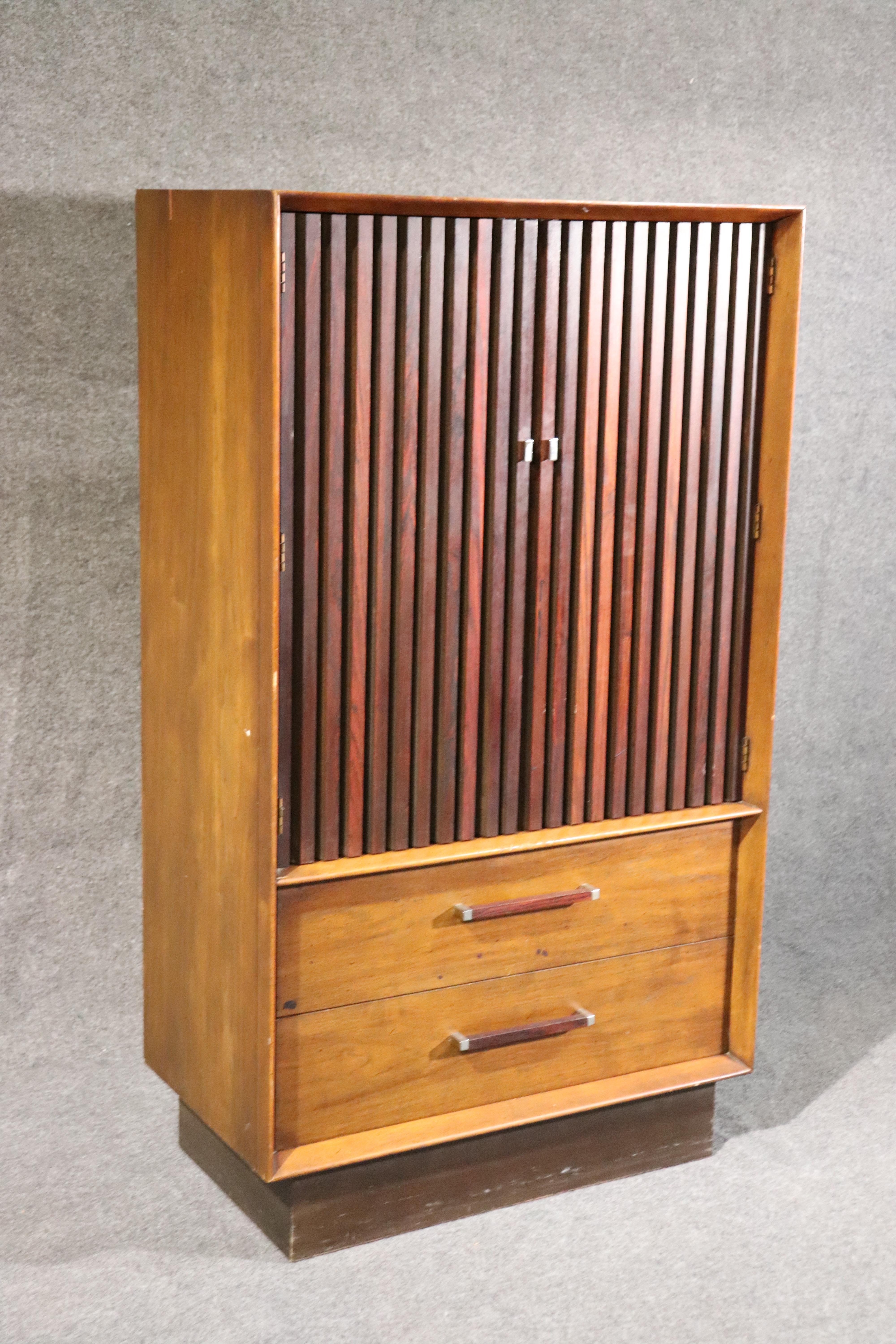 This is a superbly designed rosewood and walnut lane tall dresser. The dresser is from the 1960s or perhaps 1950s era. The dresser measures 60 inches tall x 34 wide x 19 deep. There are other matching pieces as well.