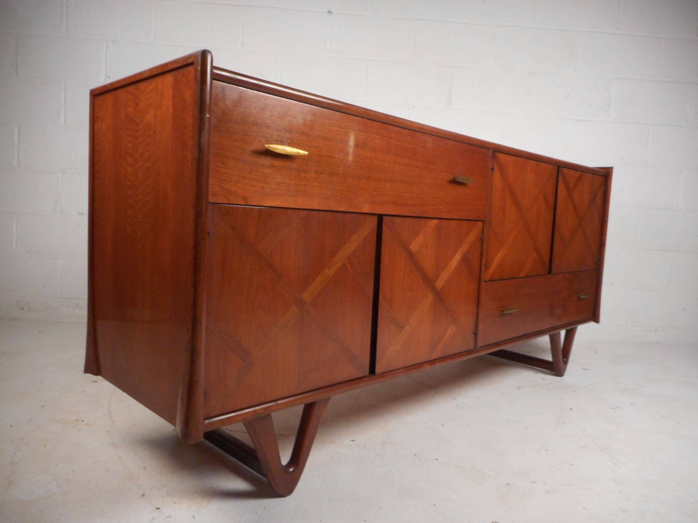 This amazing vintage modern low dresser is a sleek design with hairpin style wood sled legs and sculpted sides. This elegant piece of midcentury  furniture makes the perfect eye catching addition to any modern interior. Please confirm item location