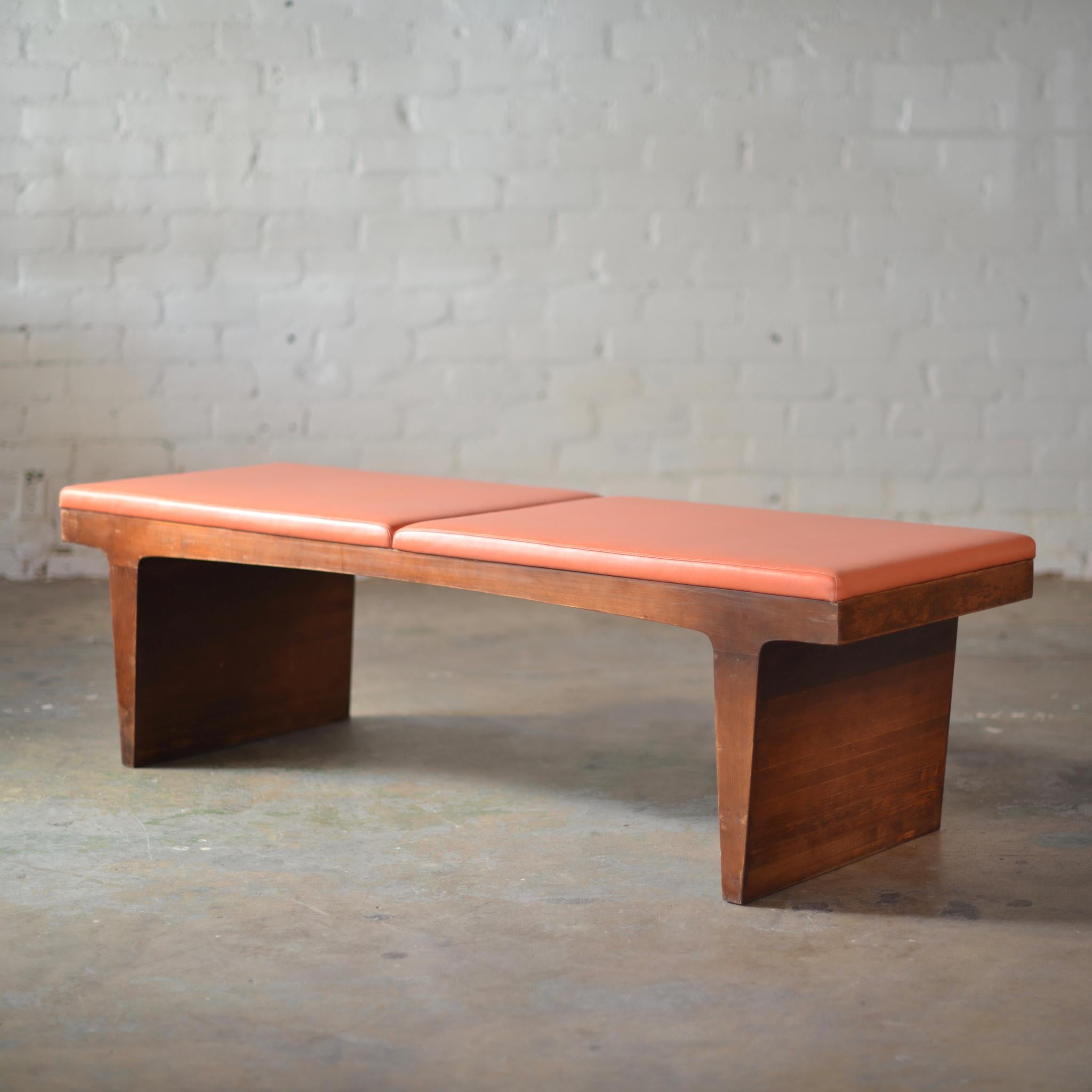 This is a great, unique vintage bench in walnut and orange vinyl upholstery. Very solid construction.