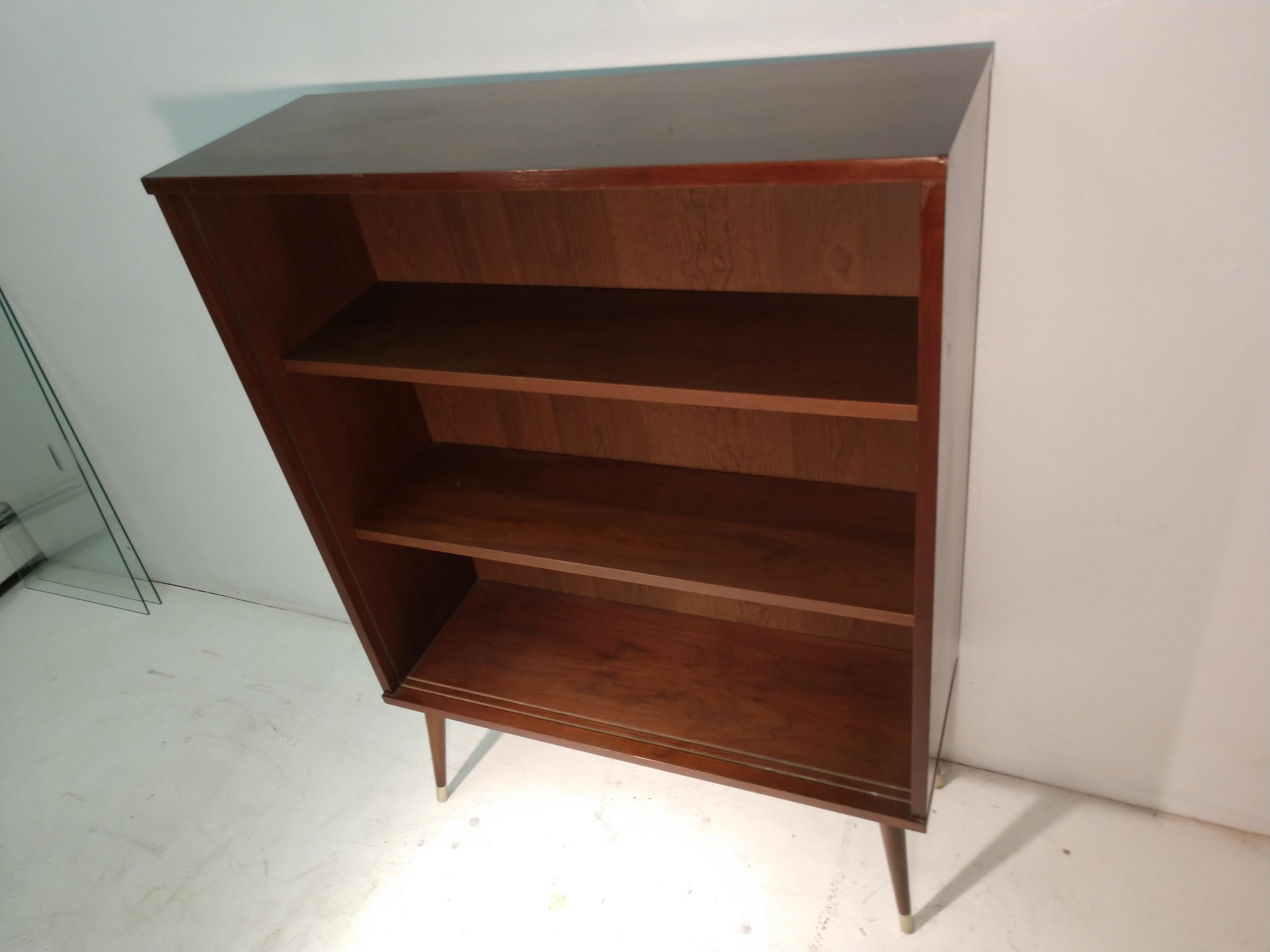 Mid-Century Modern bookcase with glass sliding doors which are removable. Two adjustable shelves.