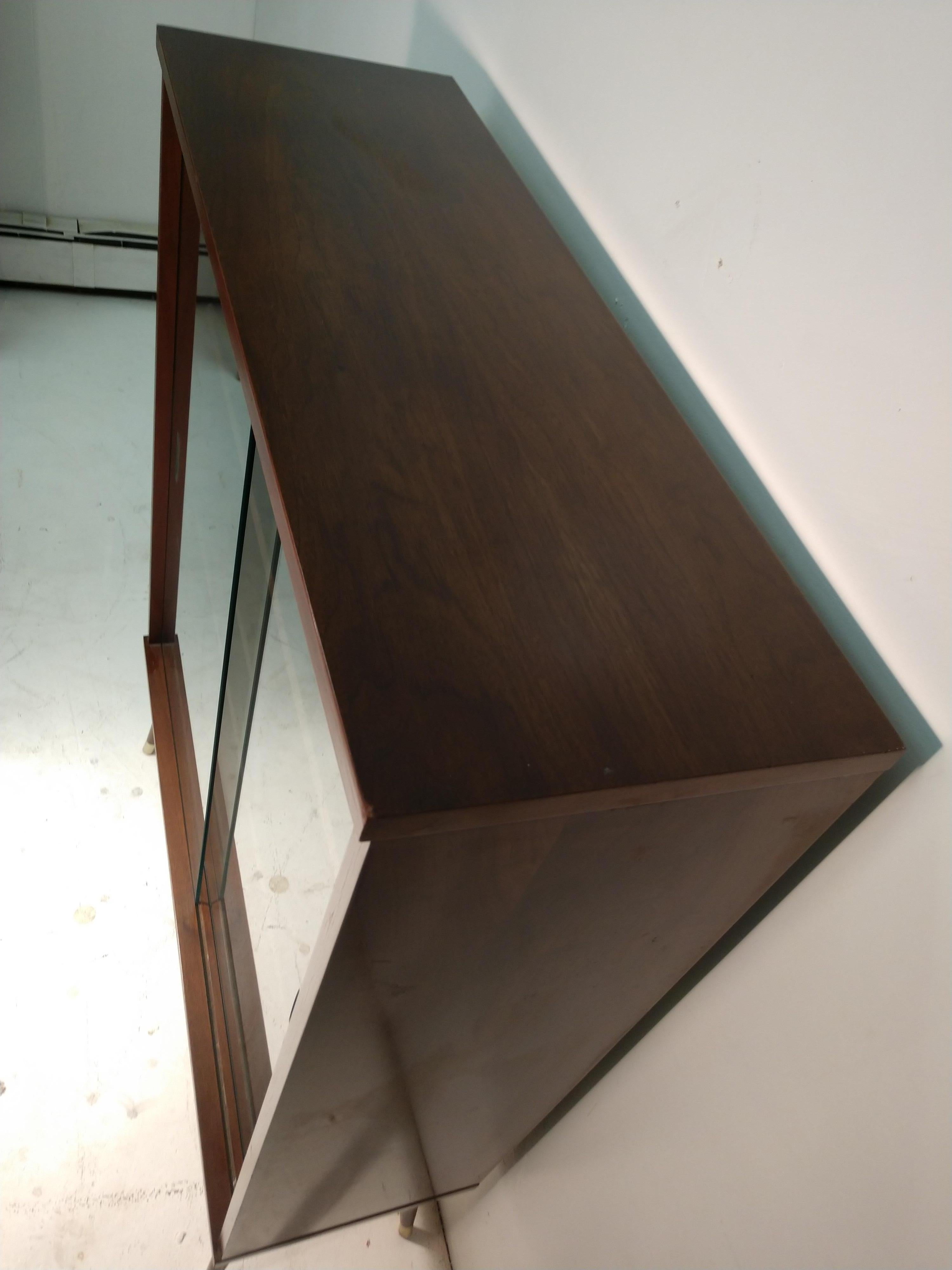 short bookcase with glass doors
