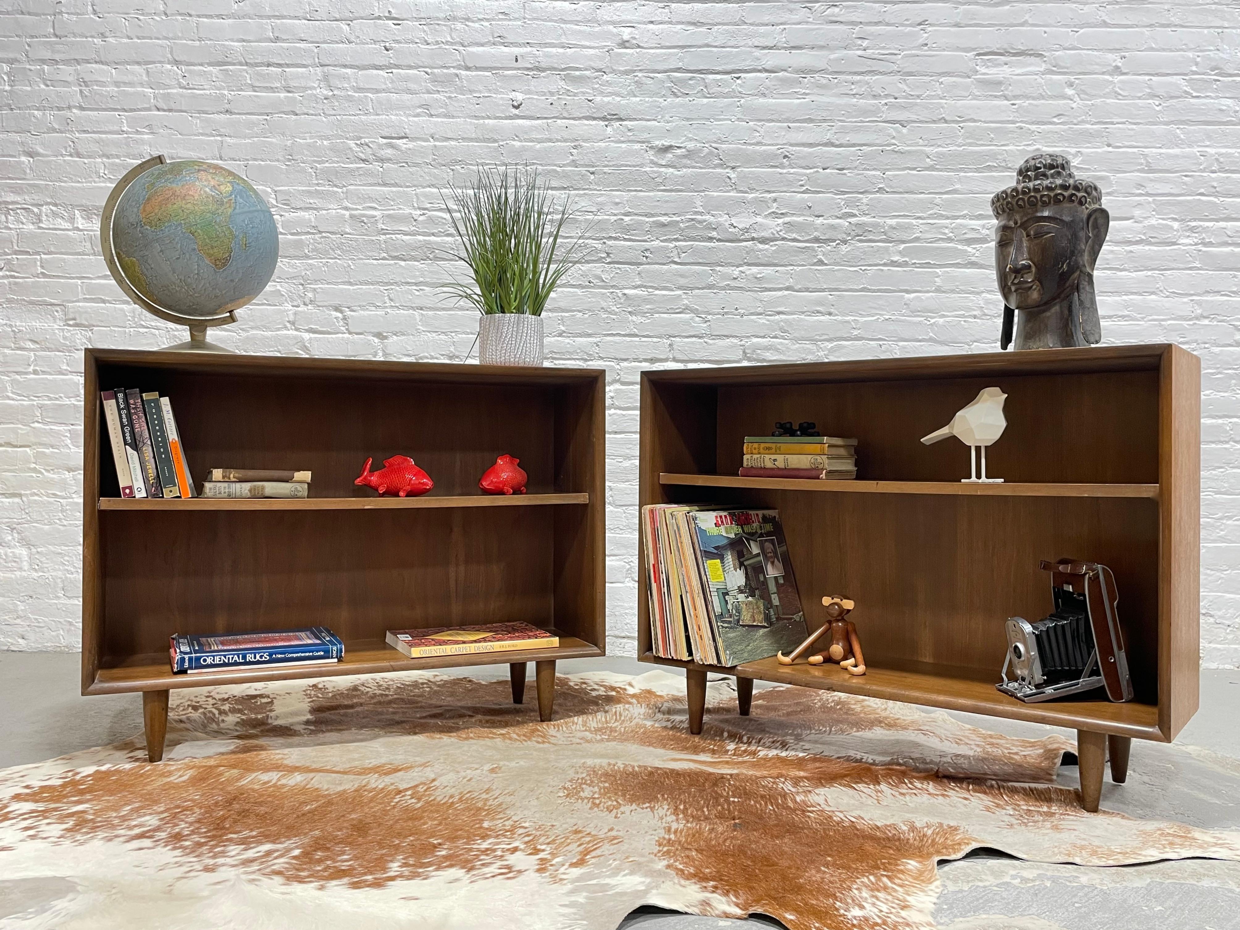 Pair of Mid Century Modern Walnut Bookcases. These apartment sized bookshelves feature super cute tapered legs and two rows of shelving space. Although the scale is small, don't be mislead by the storage space - you can fit a ton of books, vinyl