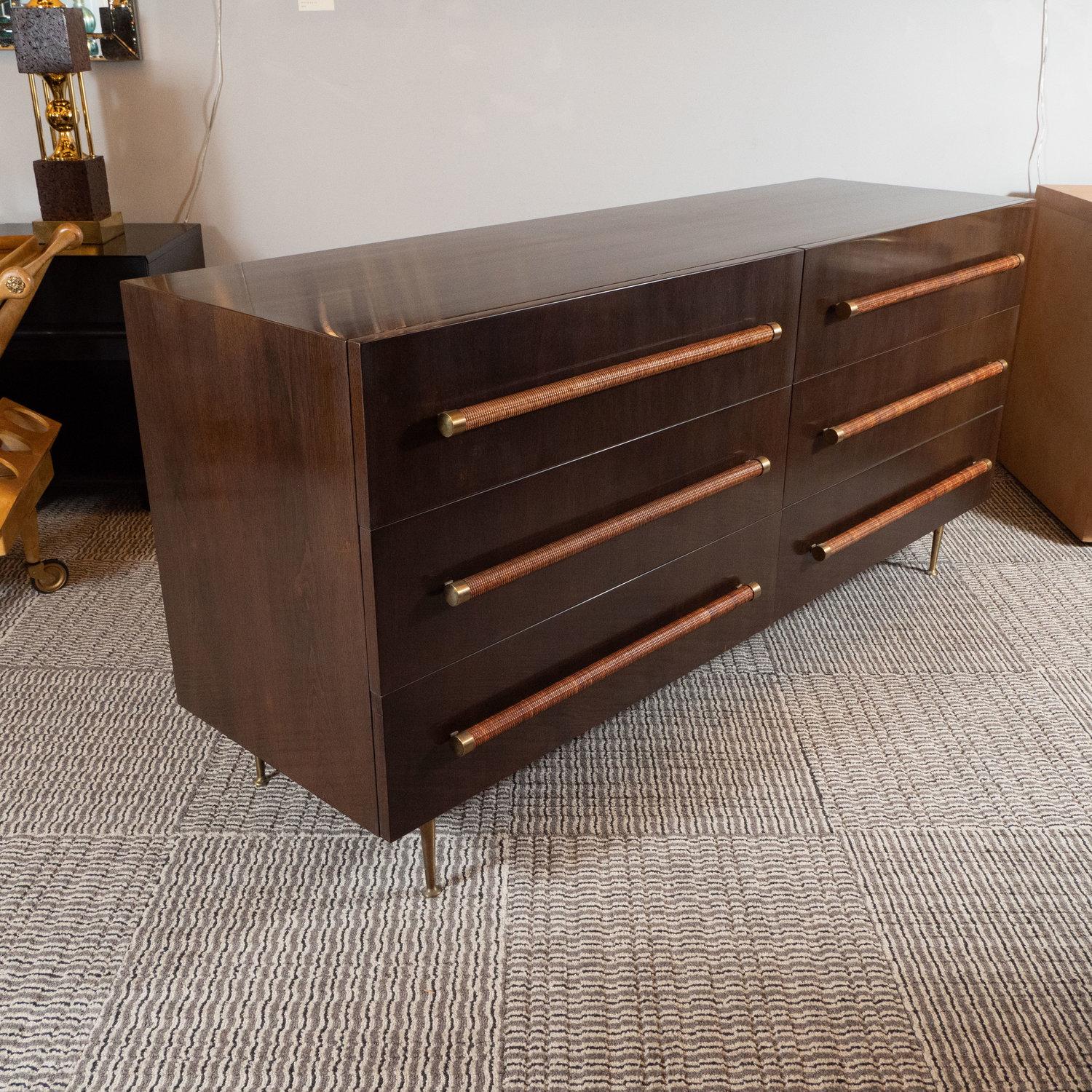 This refined and elegant Mid Century Modern dresser was designed by the celebrated T.H. Robsjohn Gibbings and handmade in Grand Rapids, Michigan circa 1950. Sitting on conical brass legs with circular bases, this stunning rectilinear sideboard was