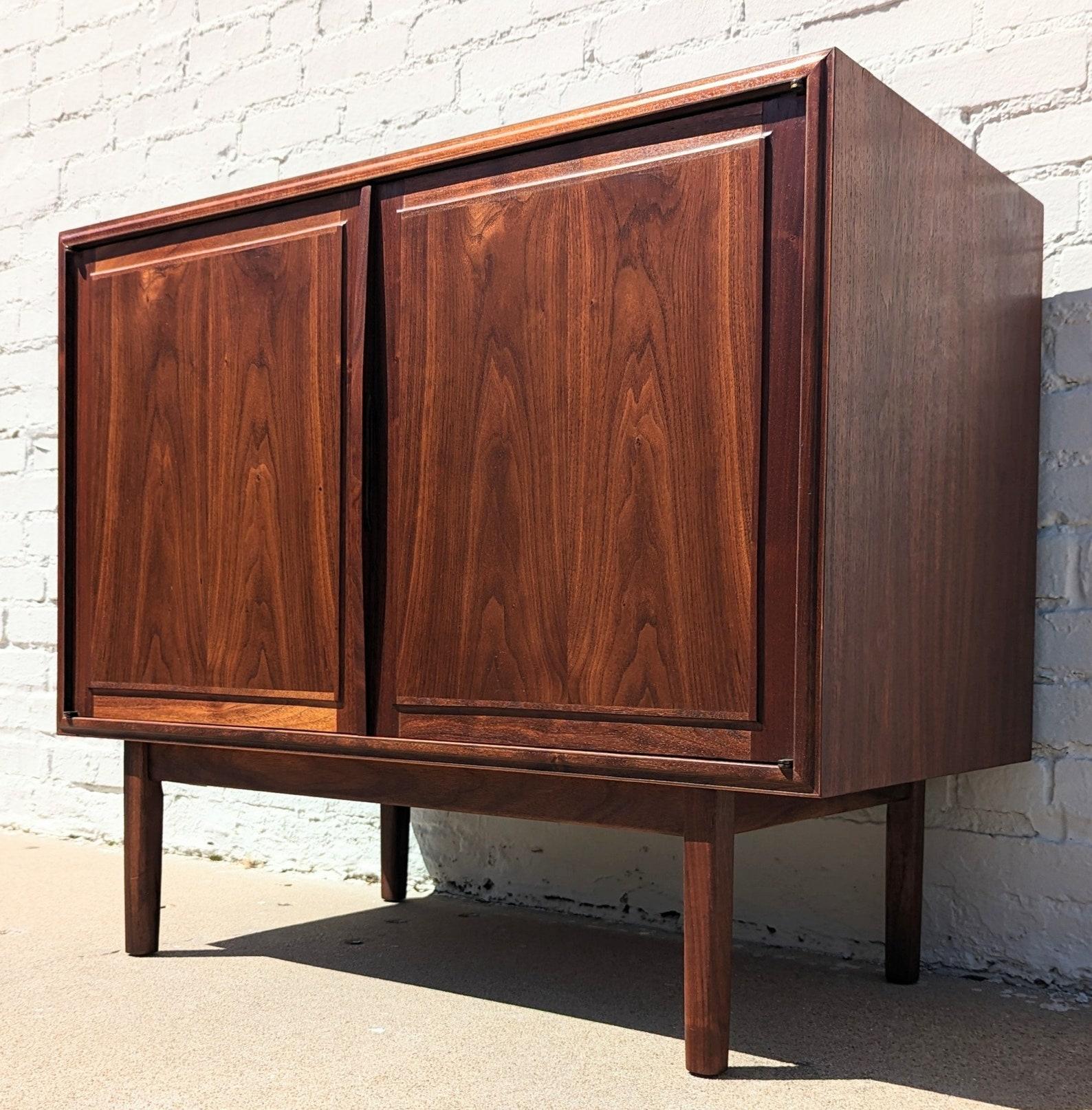 Mid Century Modern Walnut Cabinet by Founders
 
Above average vintage condition and structurally sound. Has some expected slight finish wear and scratching on top and edges. Has a couple small dings and discolorations on top. Outdoor listing
