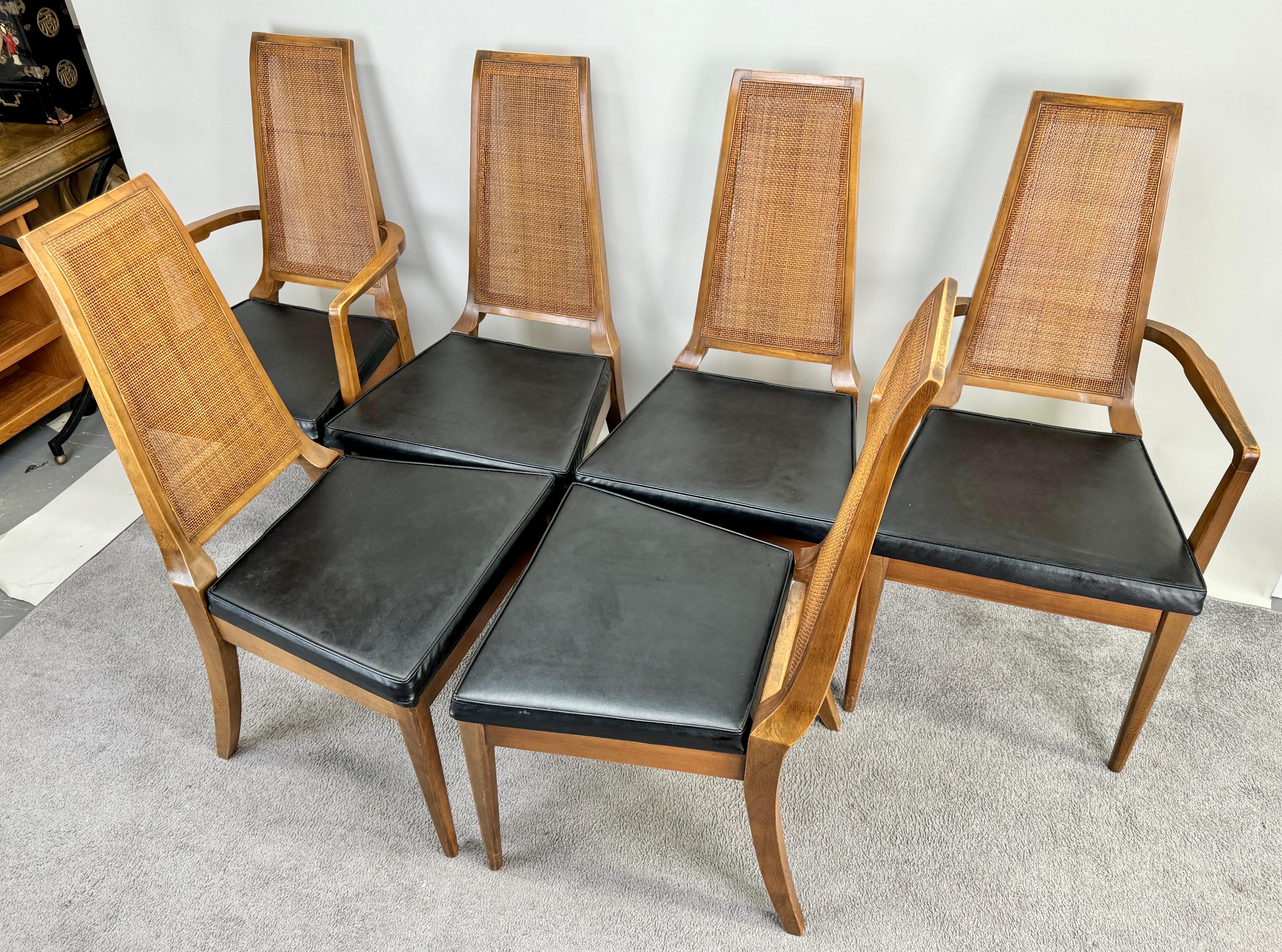 A set of six Mid Century Modern dining chairs, a testament to the refined craftsmanship of the American Furniture Co of Martinsville, VA. This collection comprises two graceful armchairs and four equally elegant regular chairs, each embodying the