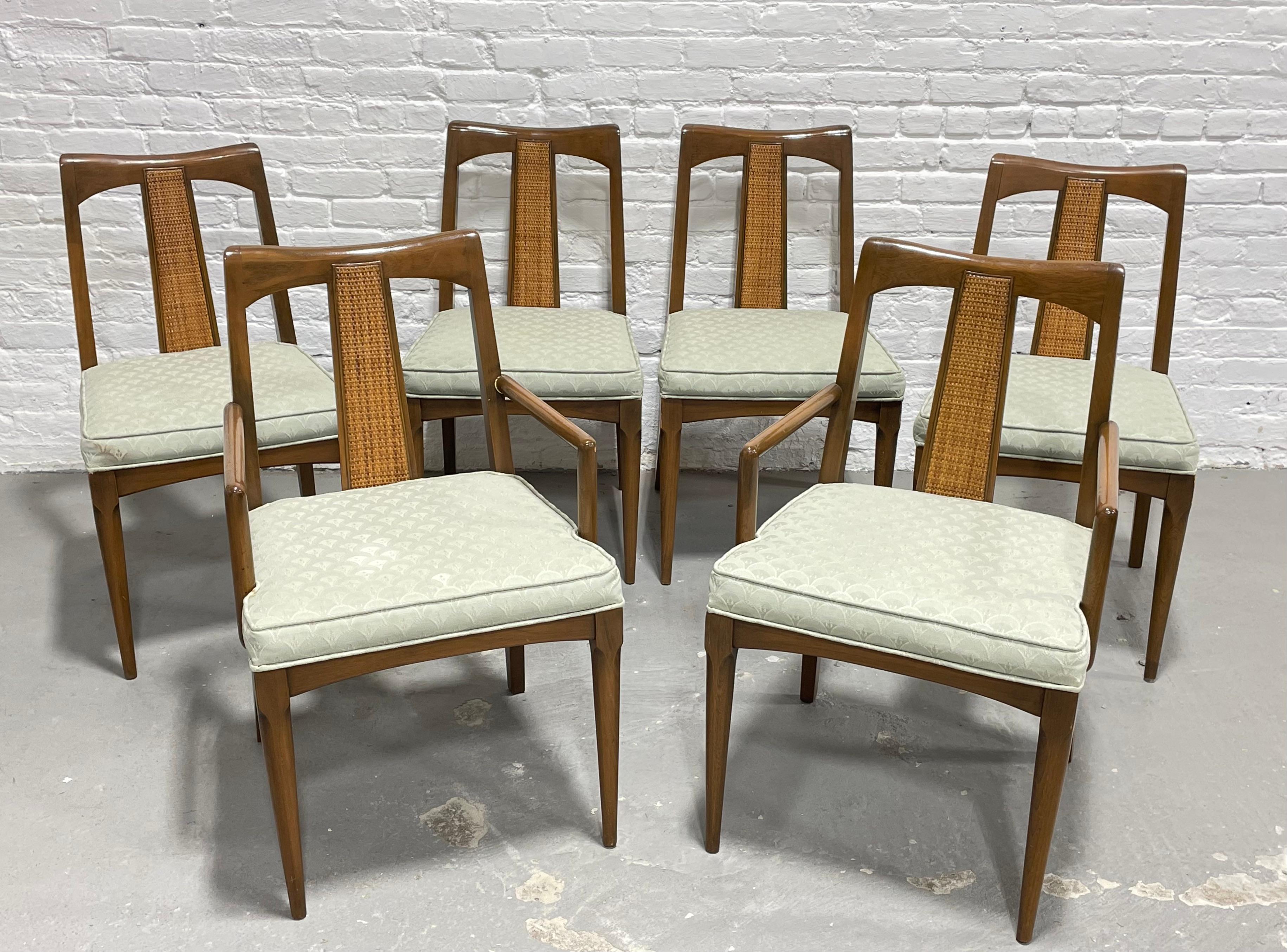 Mid-Century Modern Walnut caned back dining chairs, set of 6. These solid walnut dining chairs have gorgeous caned back supports and neutral patterned light pistachio upholstered seats. The caned backs are unbroken and lovely. Simply stunning set