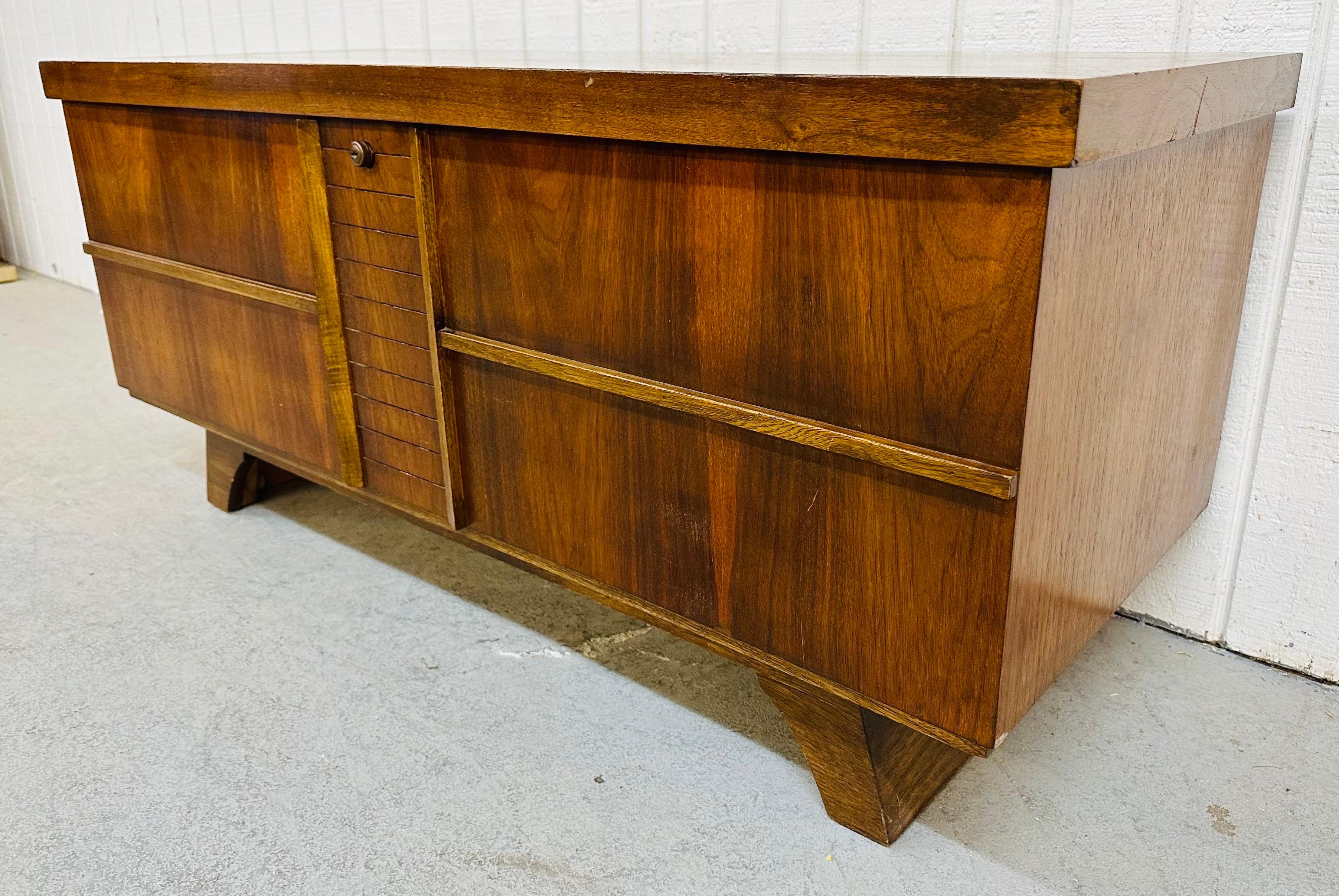 This listing is for a Mid-Century Modern Walnut Cedar Chest. Featuring a straight line design, rectangular top that opens up to a cedar lined storage area, original green velvet shelf, and a beautiful walnut finish. This is an exceptional