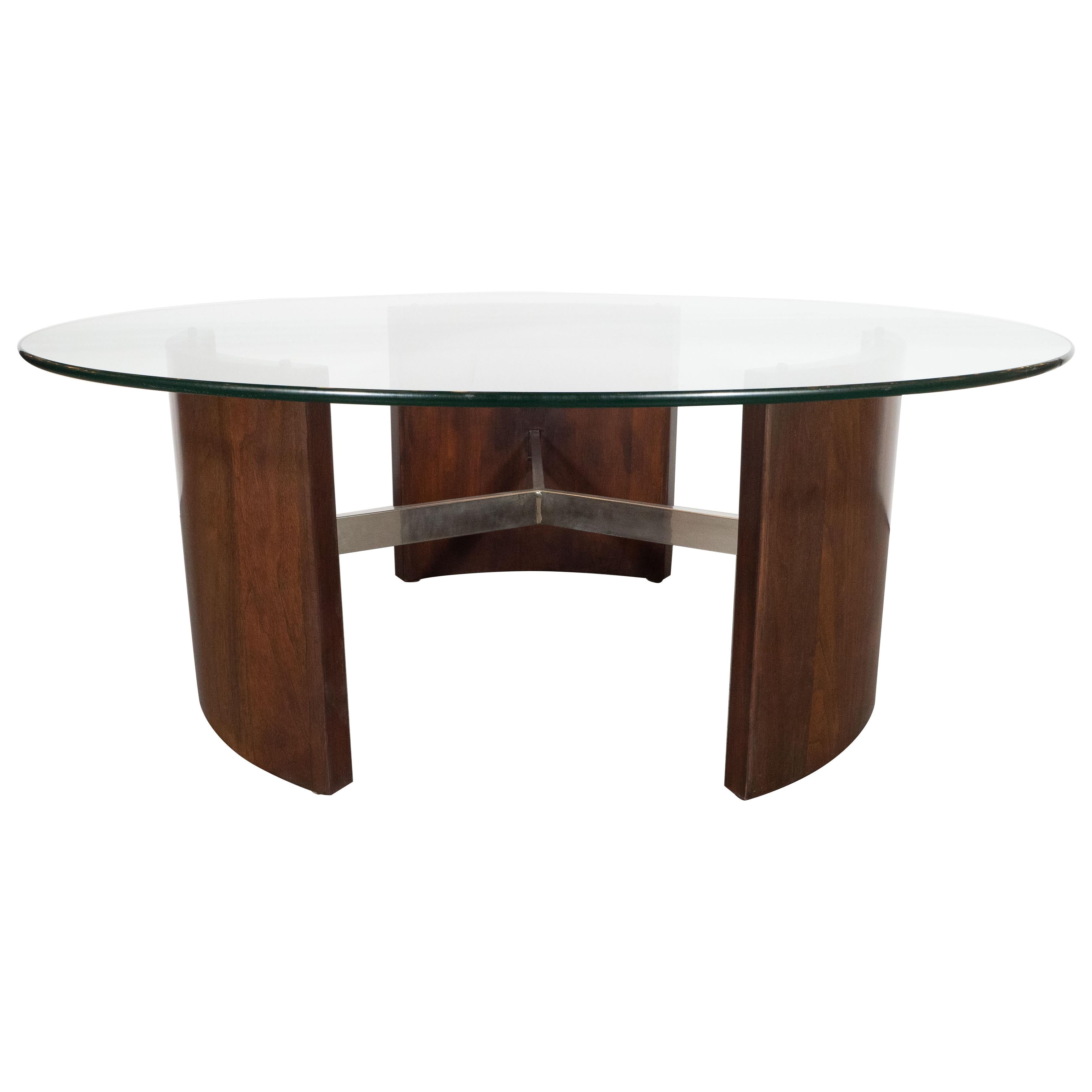 This refined Mid-Century Modern cocktail table was realized by Vladimir Kagan- one of the most celebrated designers of the 20th century- in the United States, circa 1970. It features three rectilinear bowed panels of bookmatched hand rubbed walnut