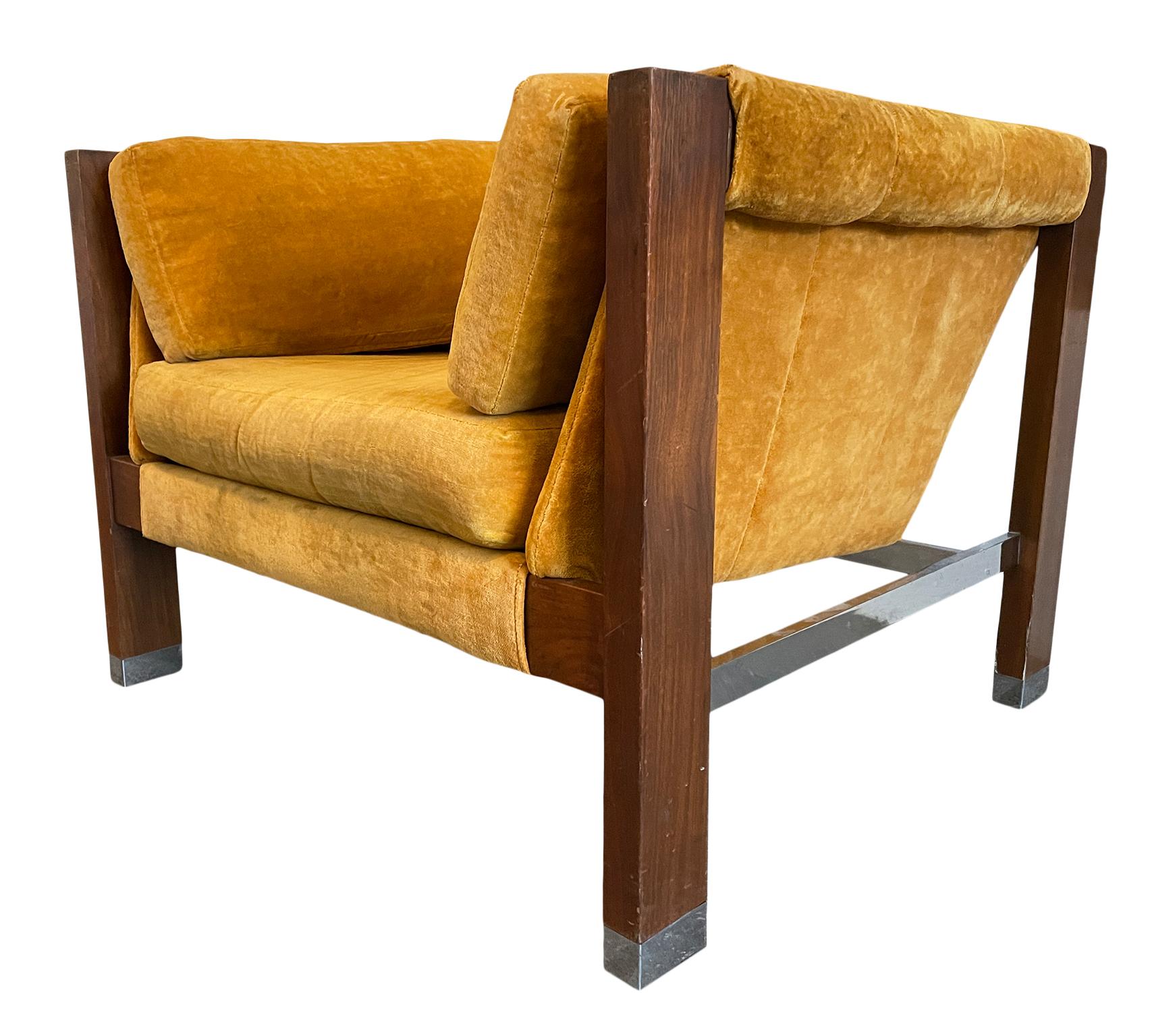 This is a beautiful walnut and chrome yellow velvet low sling lounge chair. Simple design by Founders Furniture open frame with brown walnut frame with chrome details. Upholstery is original soft yellow velvet. A fantastic piece of Mid-Century