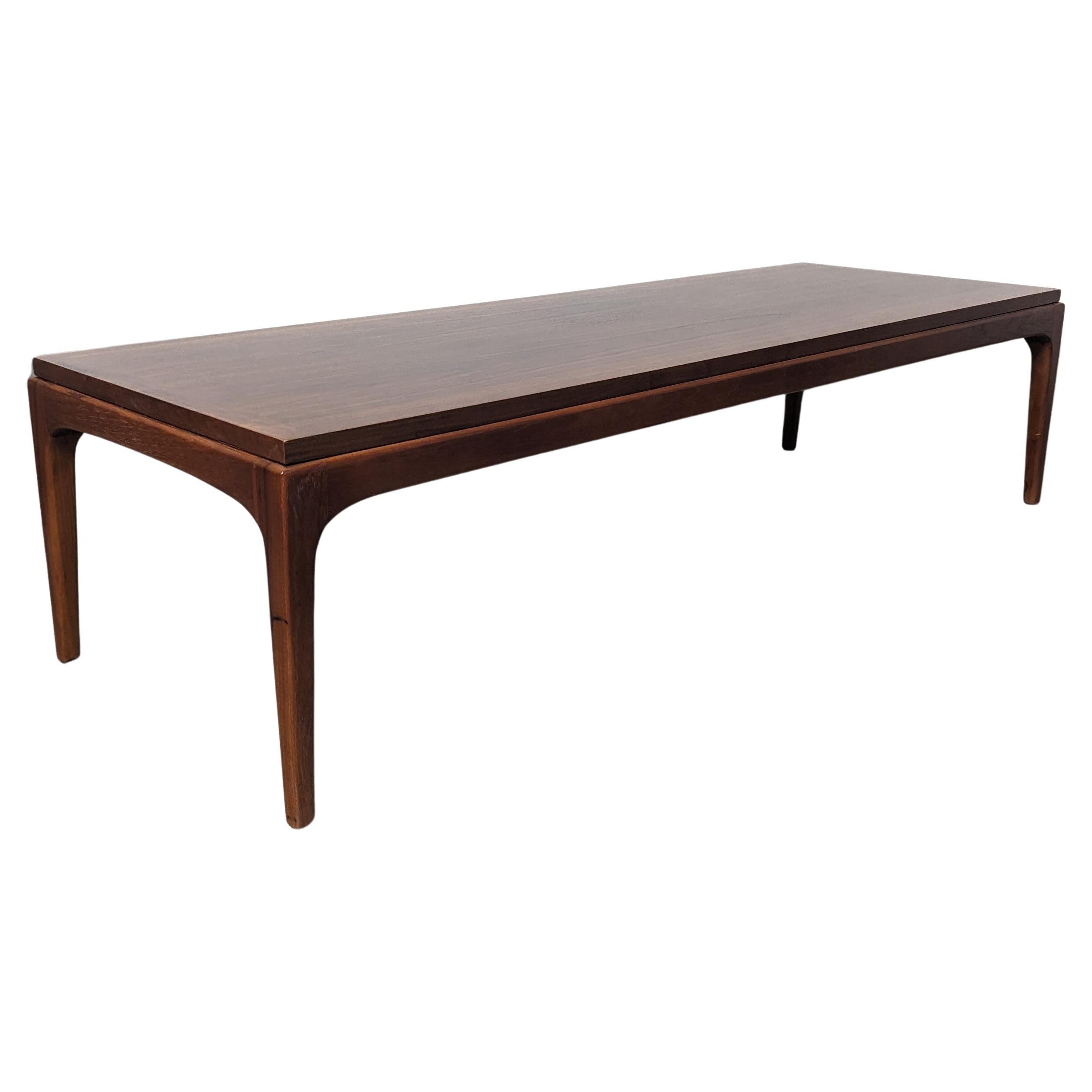 Step back in time with this beautifully restored Mid Century Modern coffee table, crafted by the renowned furniture manufacturer, Lane, during the iconic 1960s era. This piece is a true gem for those who appreciate the simplicity of vintage