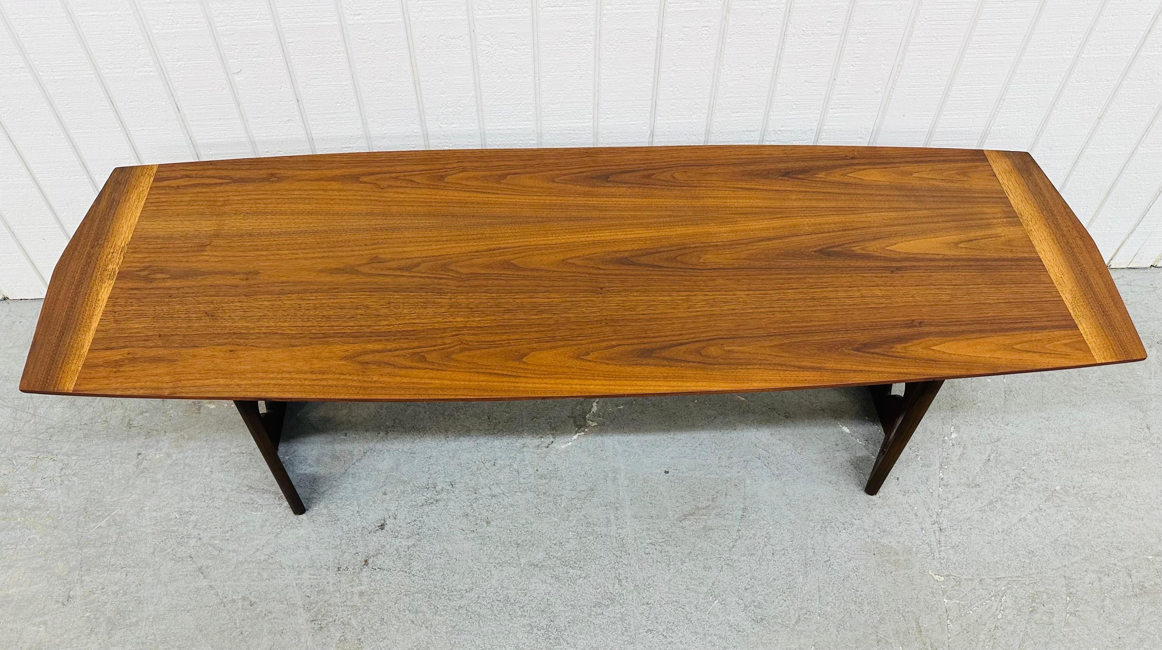 This listing is for a Mid-Century Modern Walnut Coffee Table. Featuring a surfboard style top, matching sculpted base on each side, and a beautiful walnut finish. This is an exceptional combination of quality and design!