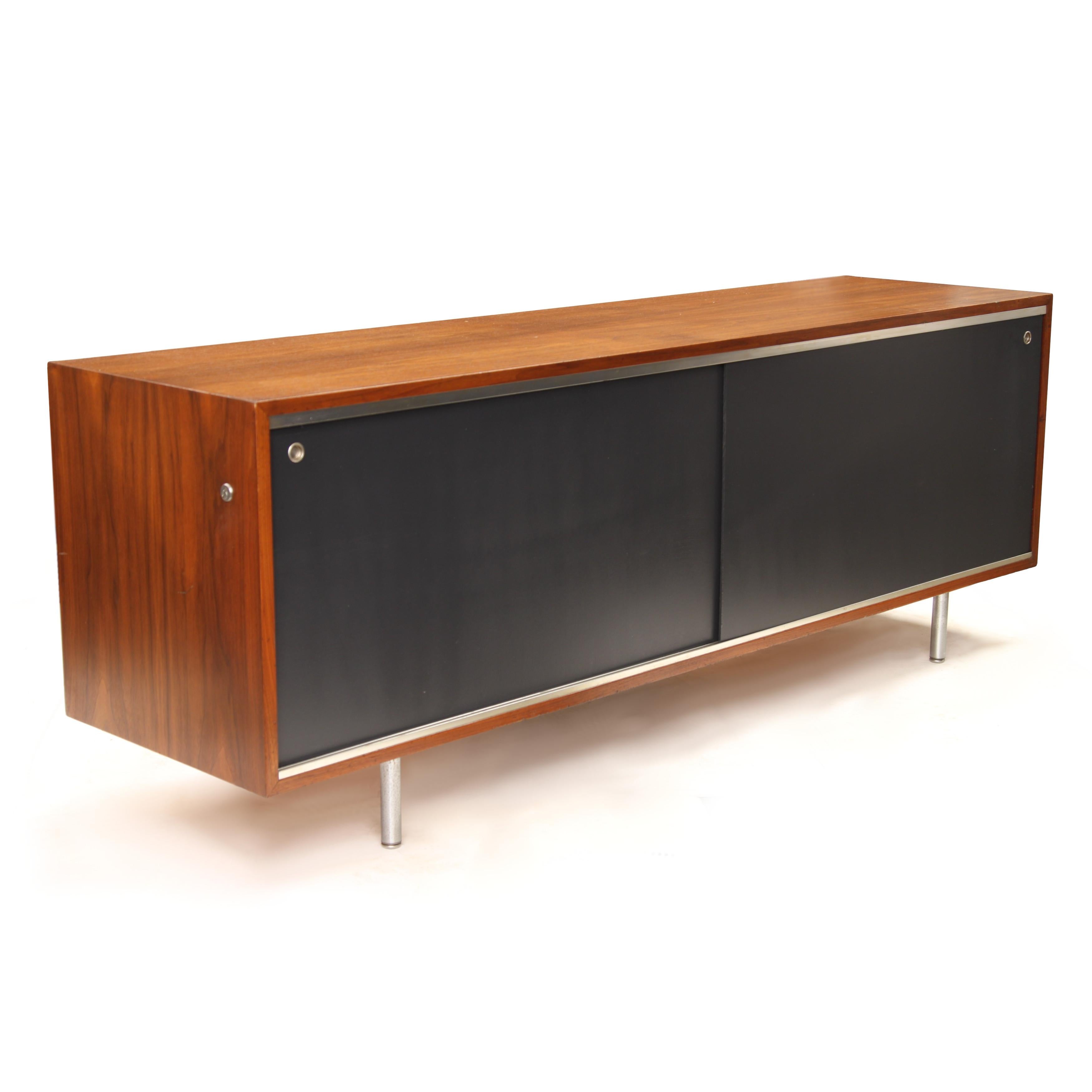 Original 1960's Executive credenza by George Nelson for Herman Miller. 

Credenza Features:

Walnut Veneer Cabinet
Brushed Chrome Legs
70