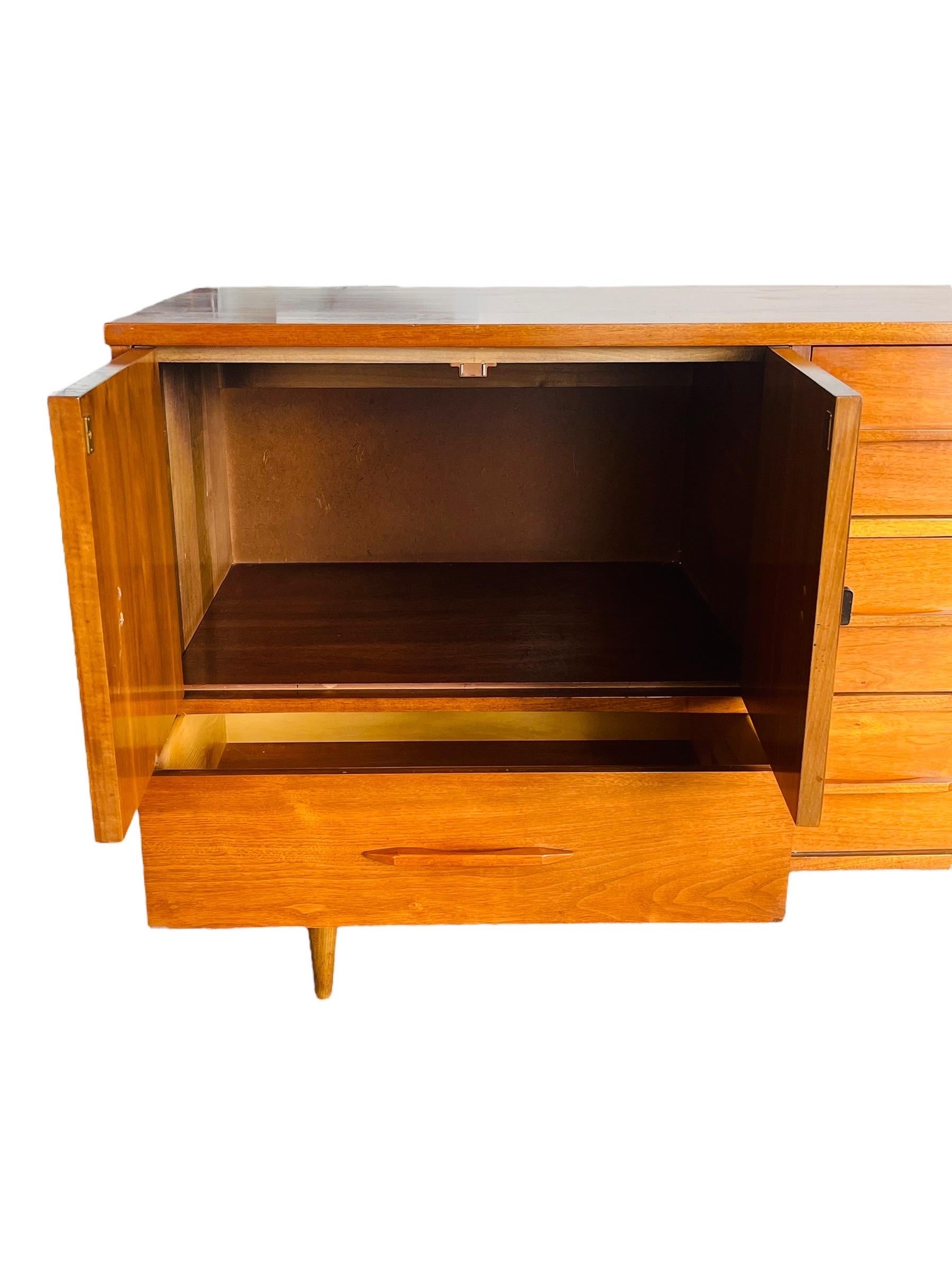 Love this piece! Lots of storage. The drawers have beautiful sculptured drawer pulls. This piece is in very good original condition. There are signs of use and may include light scratches, scuffs and marks and a few very small chips in the veneer in
