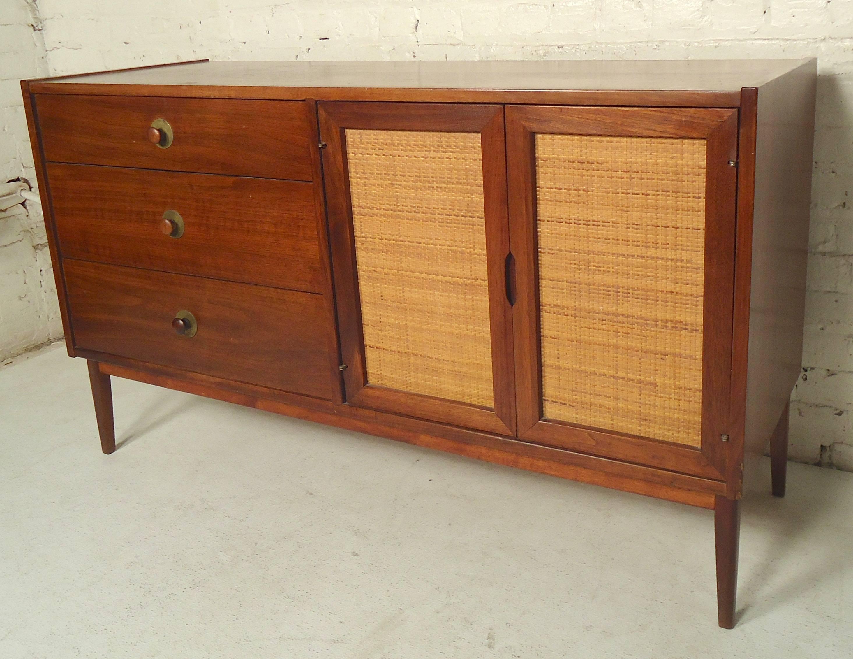 Mazor Furniture three drawer credenza with cane front cabinet doors. Sculpted walnut pulls are accented by brass rings.

(Please confirm item location, NY or NJ, with dealer).
 