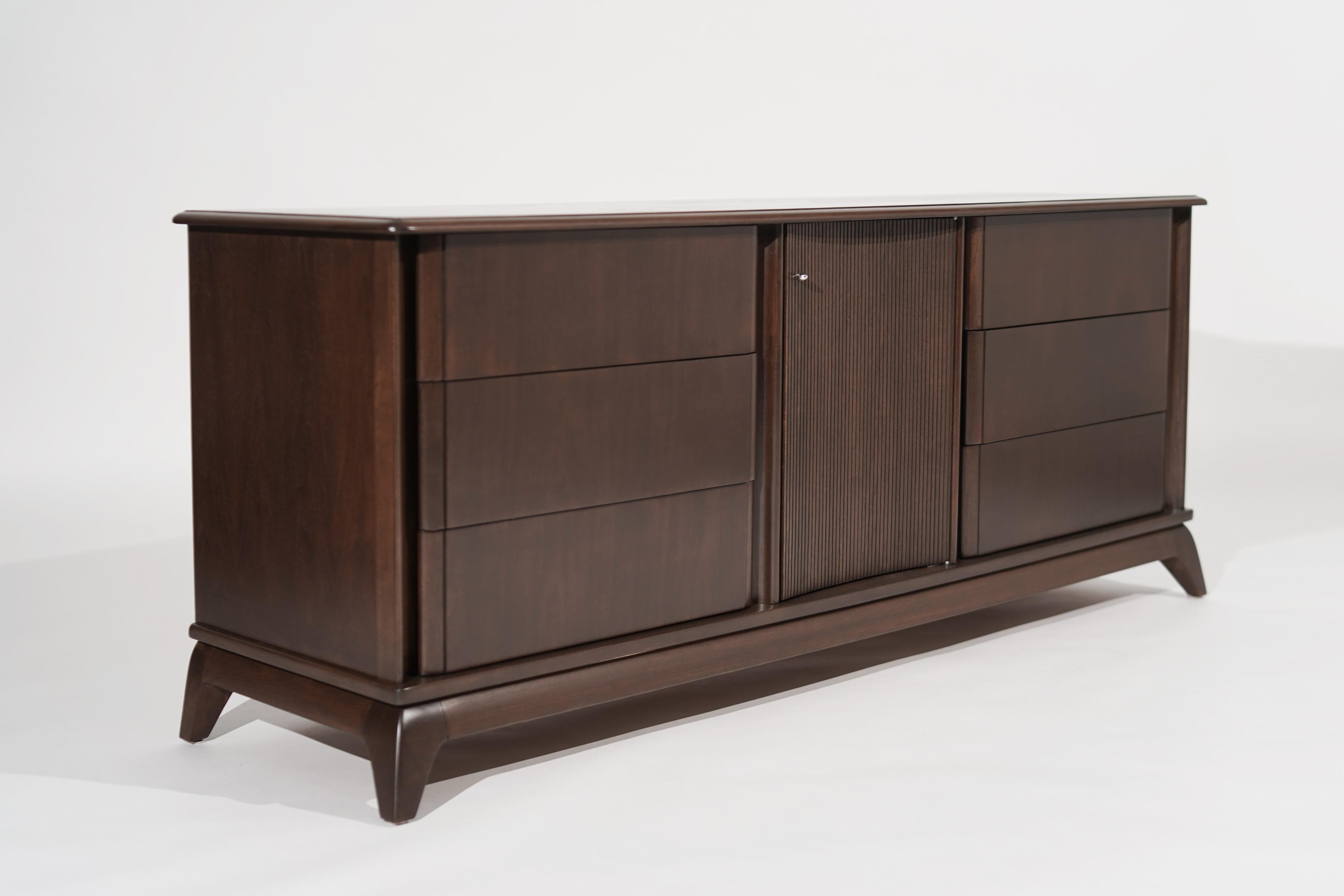 A stunning credenza executed in walnut features nine drawers providing ample storage. In the style of T.H. Robsjohn-Gibbings.
 The restoration team completely restored it by matching its original medium walnut tone. Circa 1950-1959.

Other